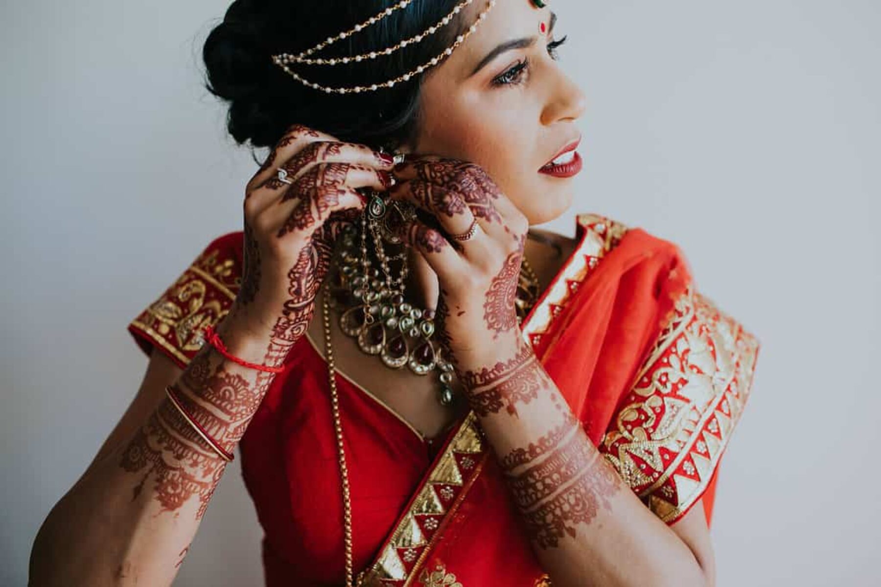 stunning Hindu bride in vibrant red and gold wedding attire