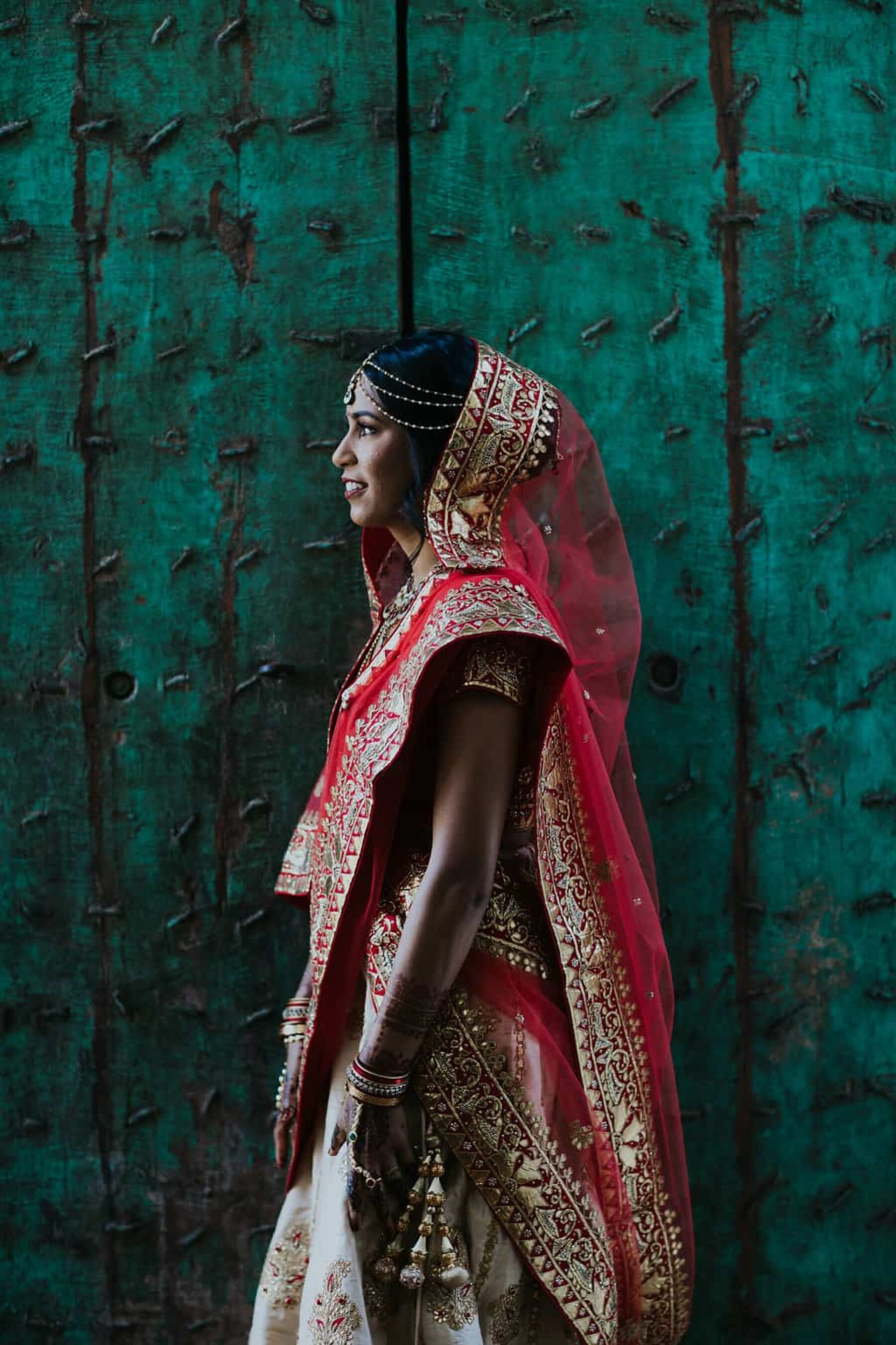 stunning Hindu bride in vibrant red and gold wedding attire