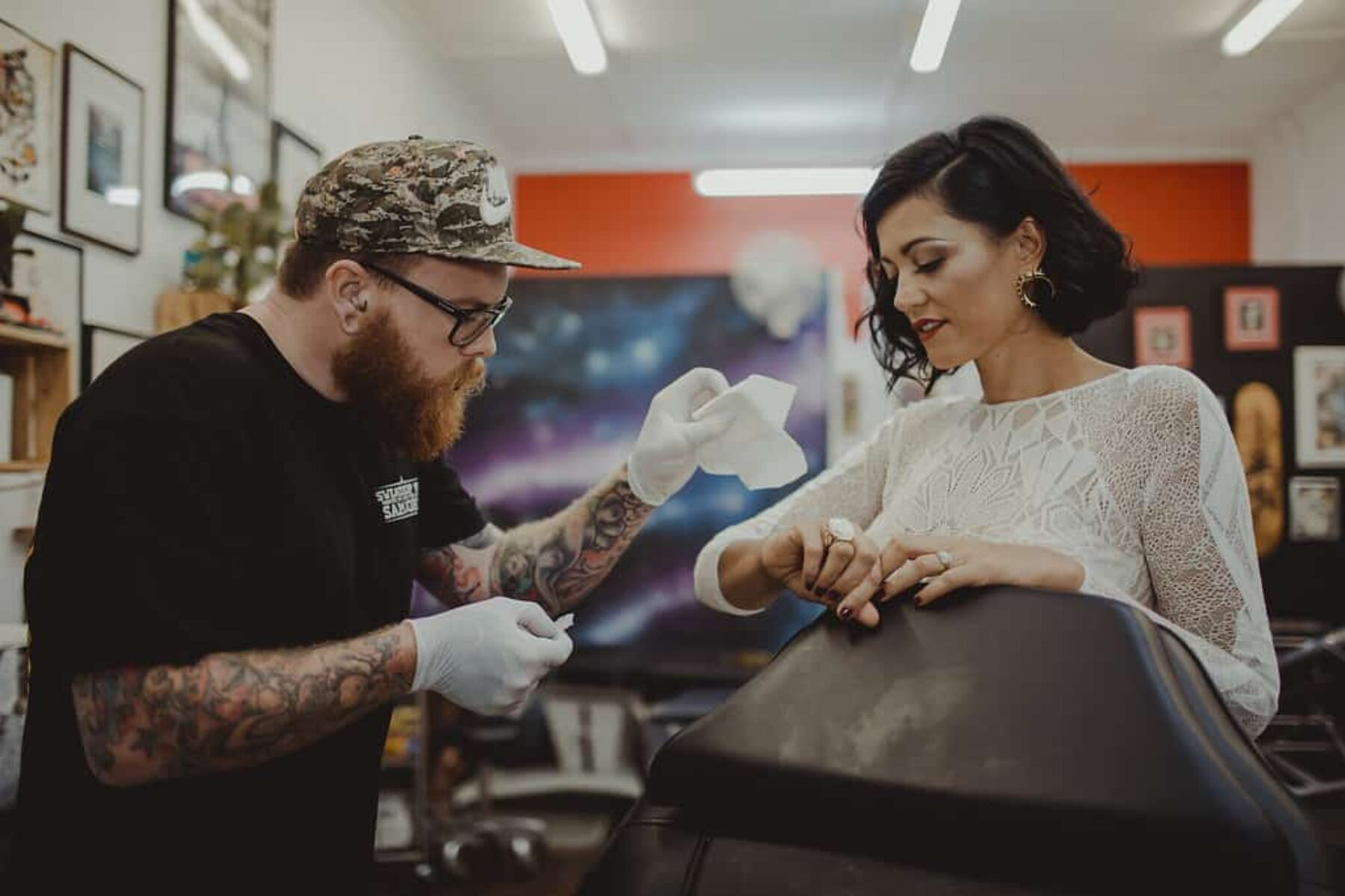 bride getting tattooed on her wedding day
