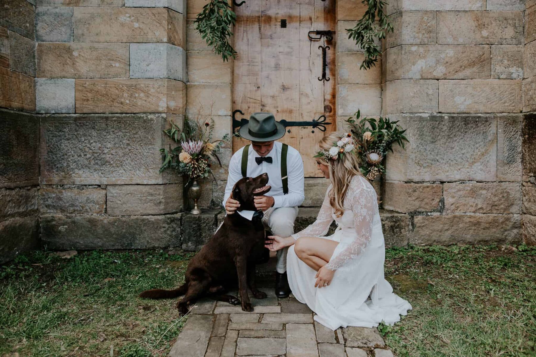 bride and groom with labrador