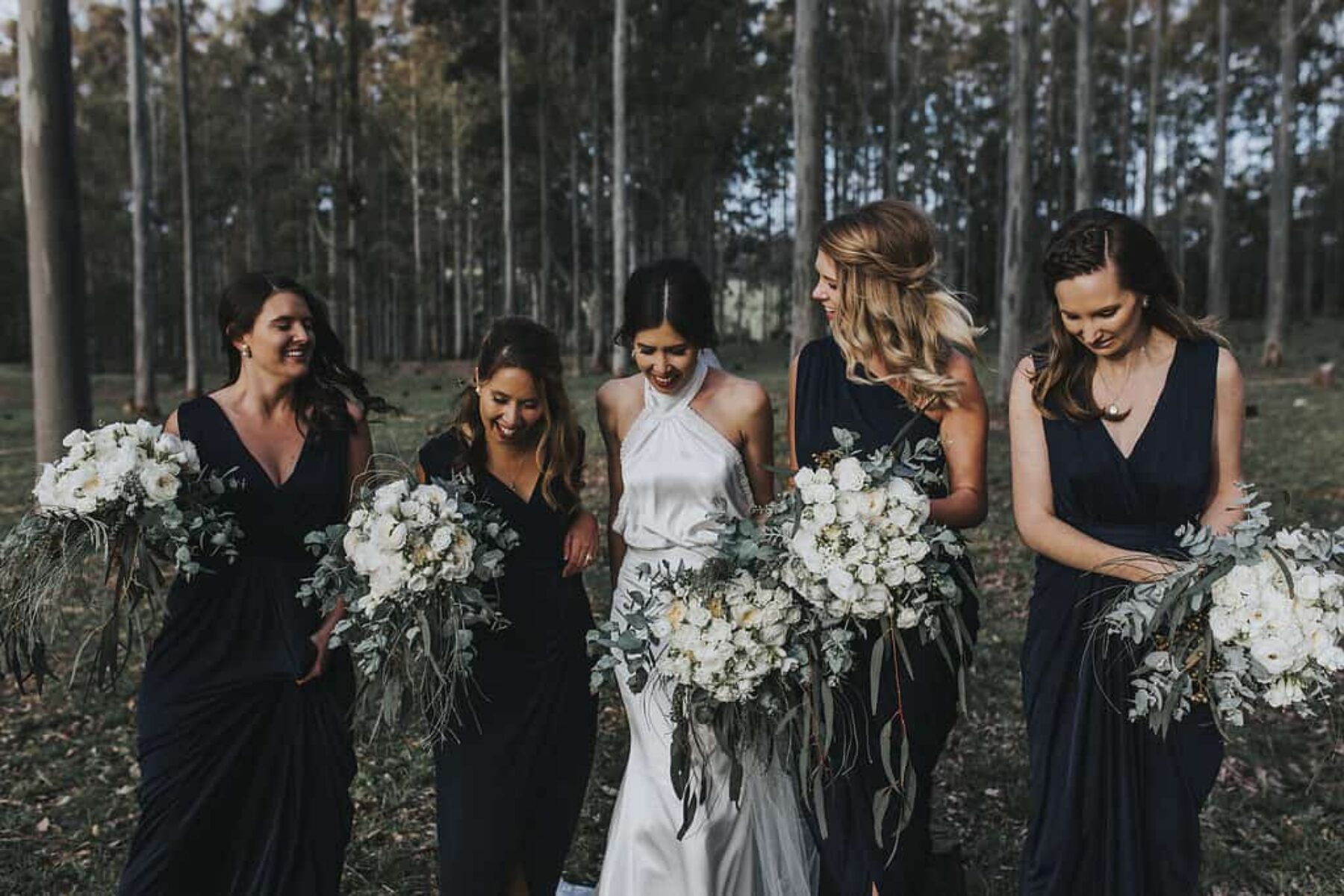 navy bridesmaids with green and white bouquets