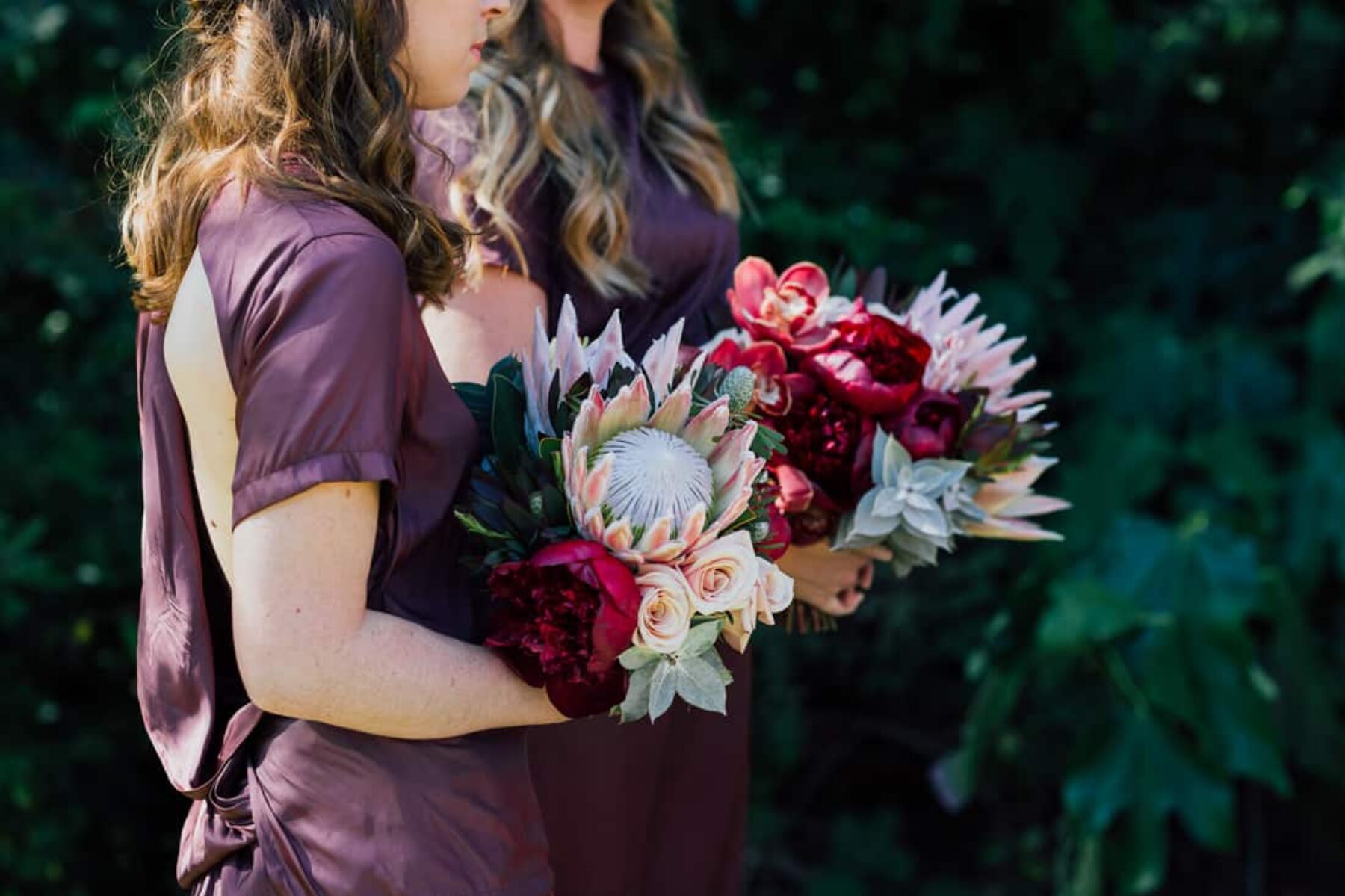 bridesmaids with pink protea bouquets