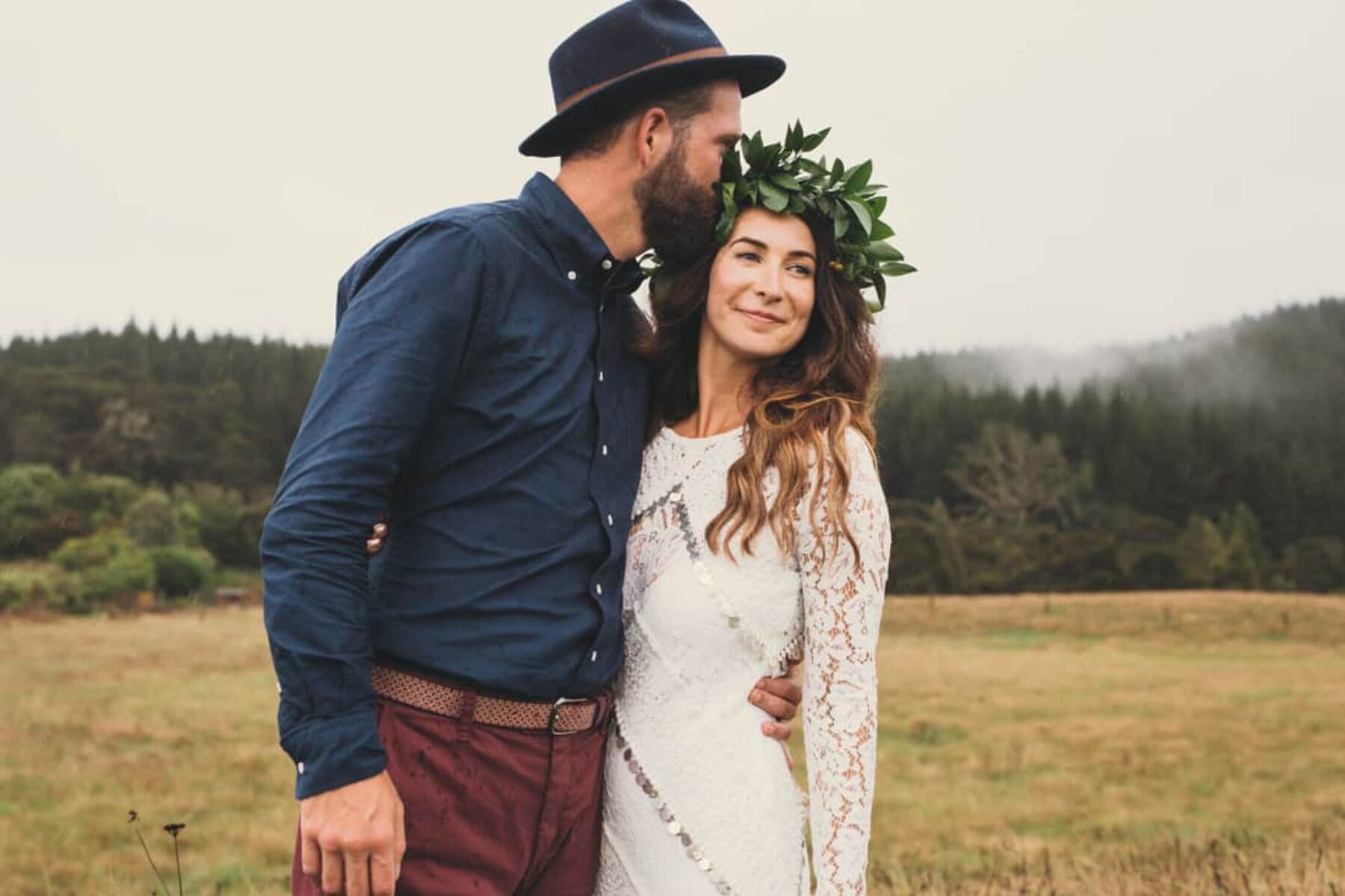 boho bride with foliage crown and hipster groom