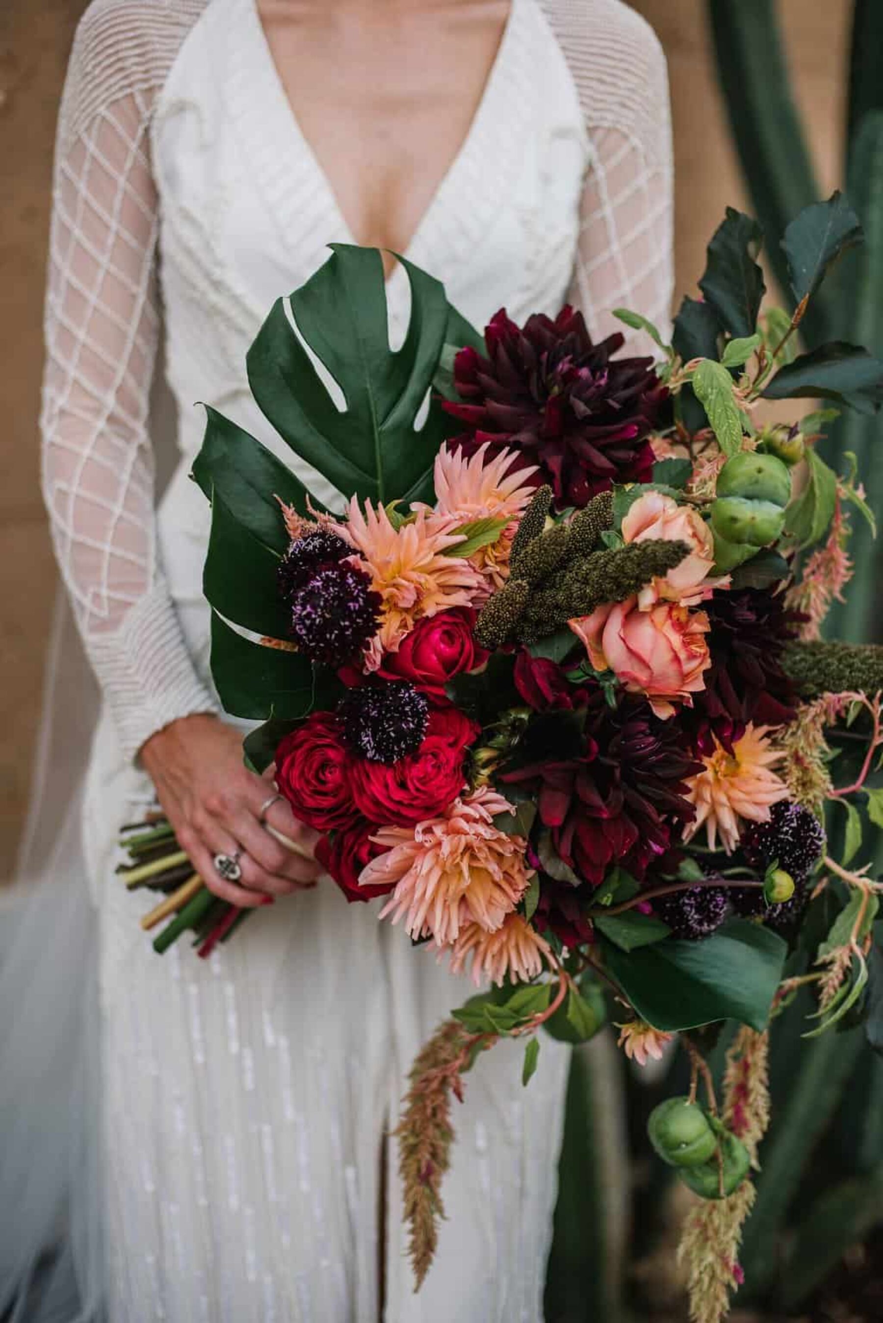 mixed pink bridal bouquet with dahlias and monstera leaf