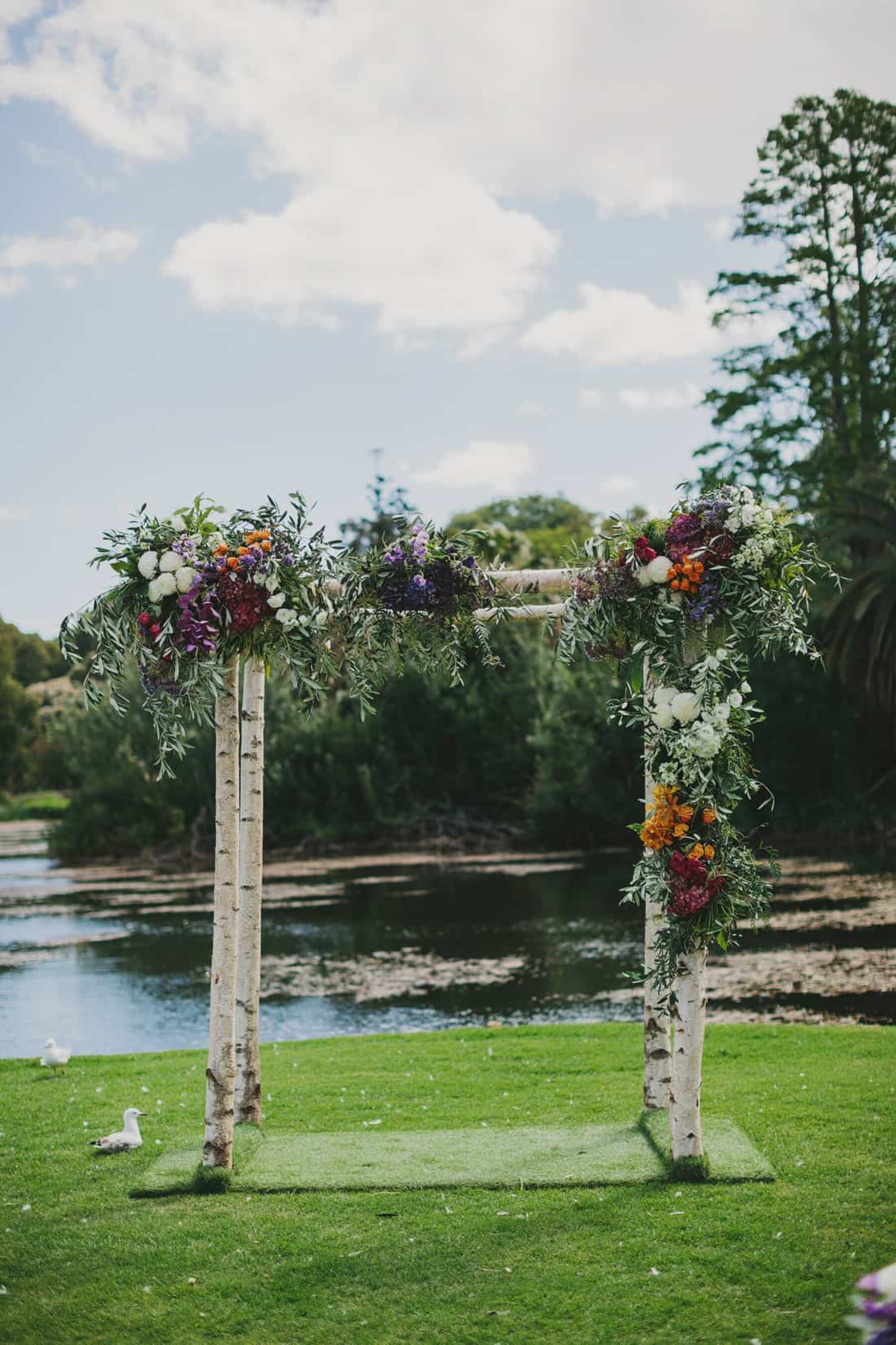 birch wood wedding arbour with flowers