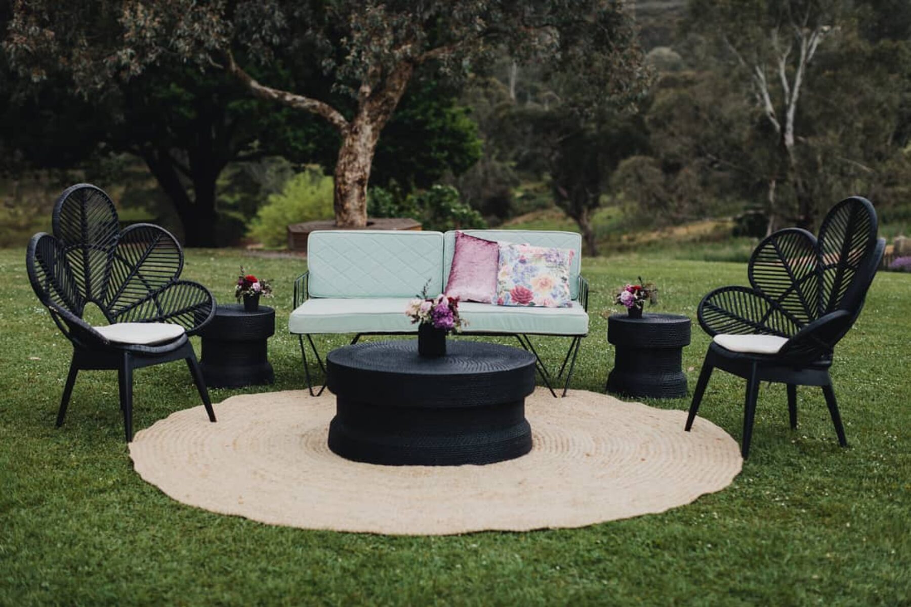 lawn lounge setup with black peacock chairs
