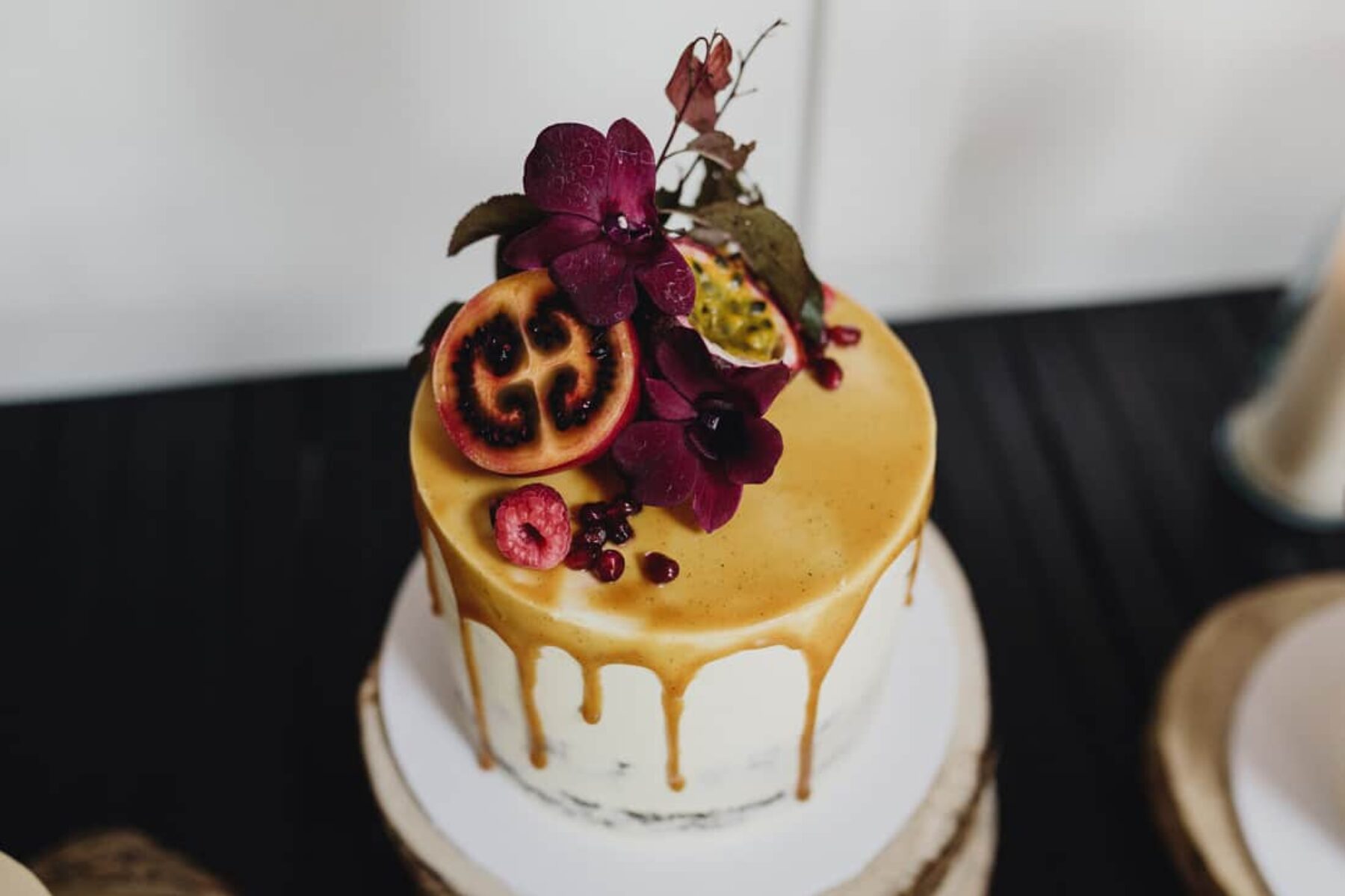 caramel drip cake with fresh fruit and flowers