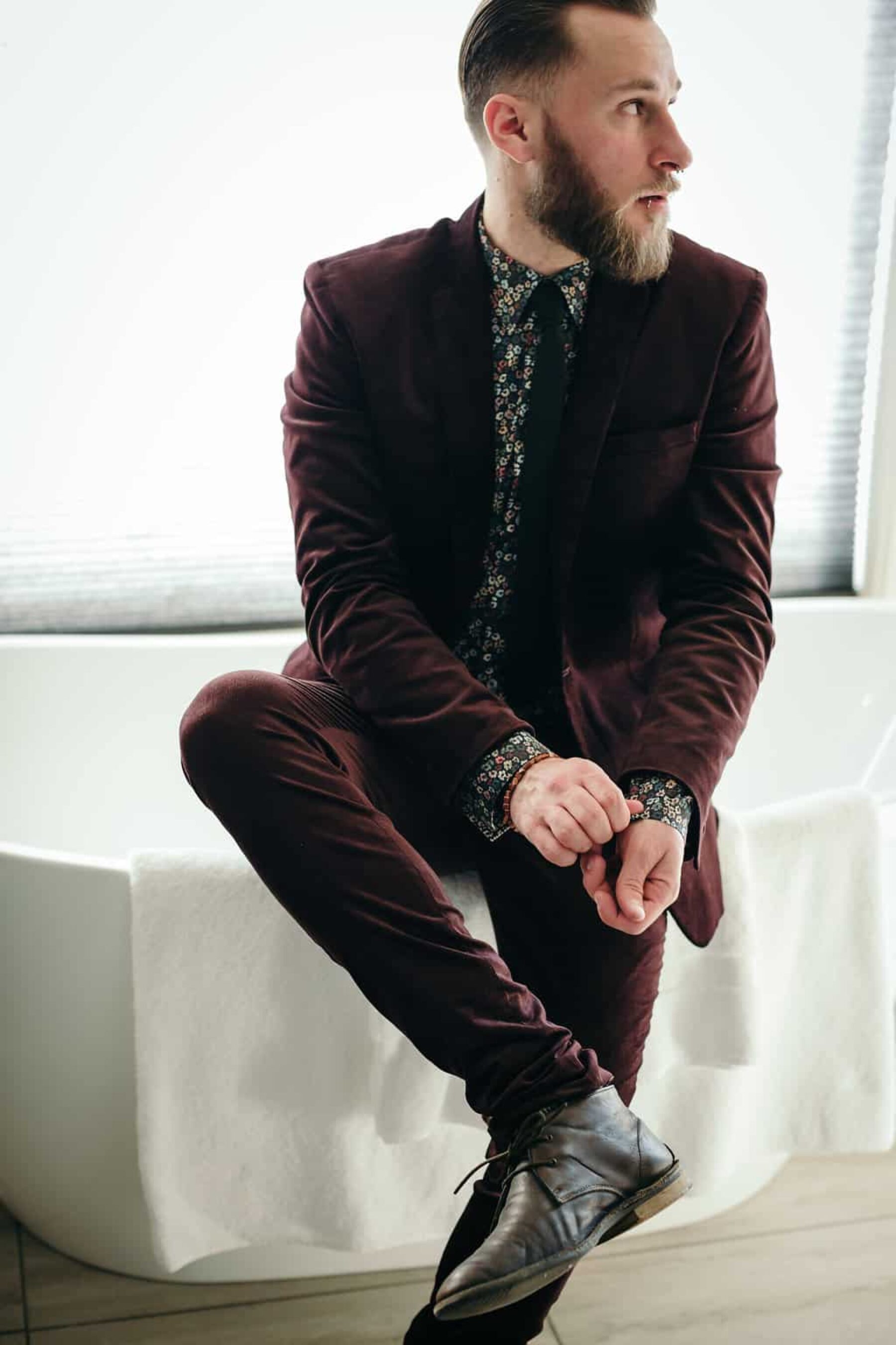 Groom in burgundy suit with floral shirt