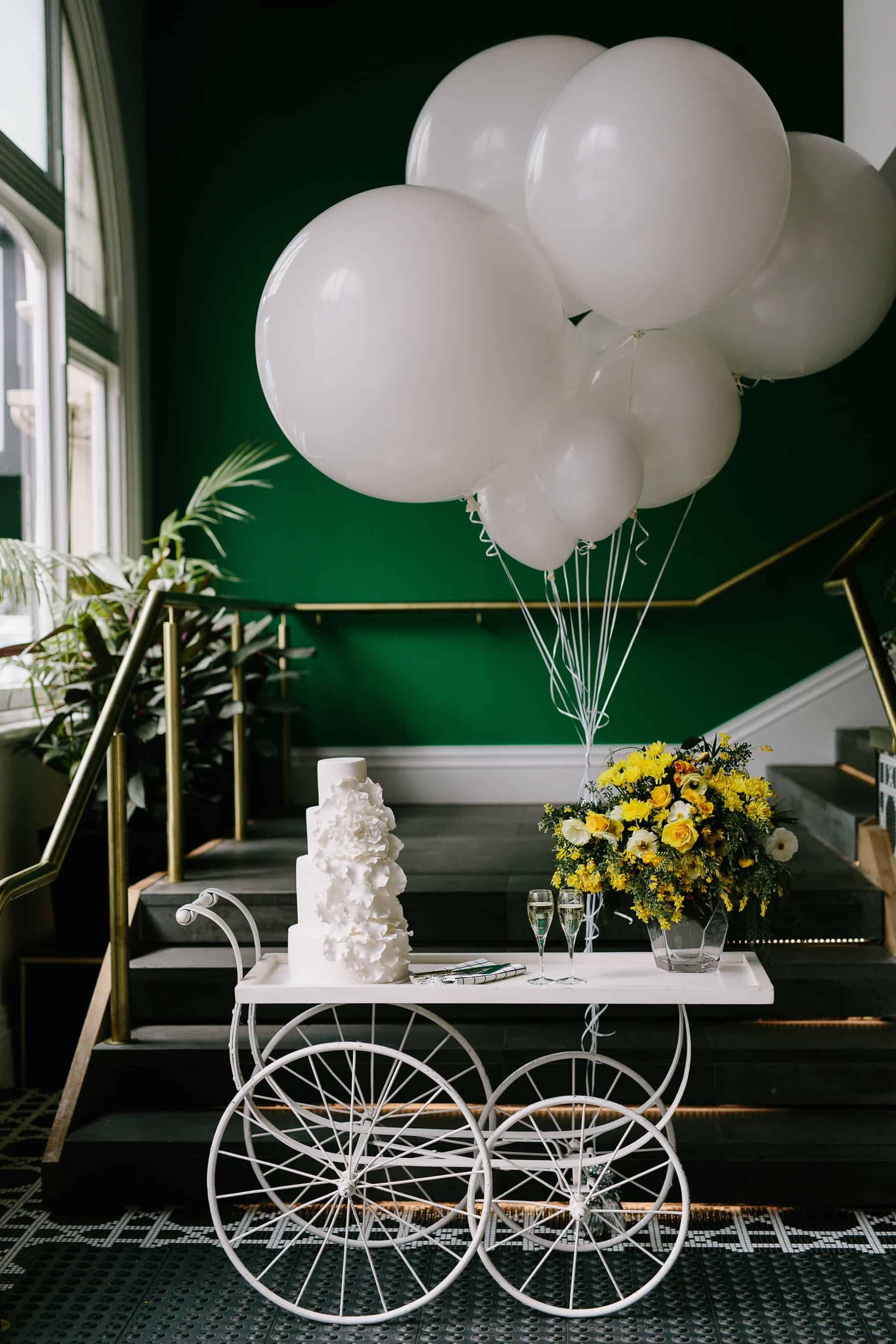 wedding cake cart with giant balloons