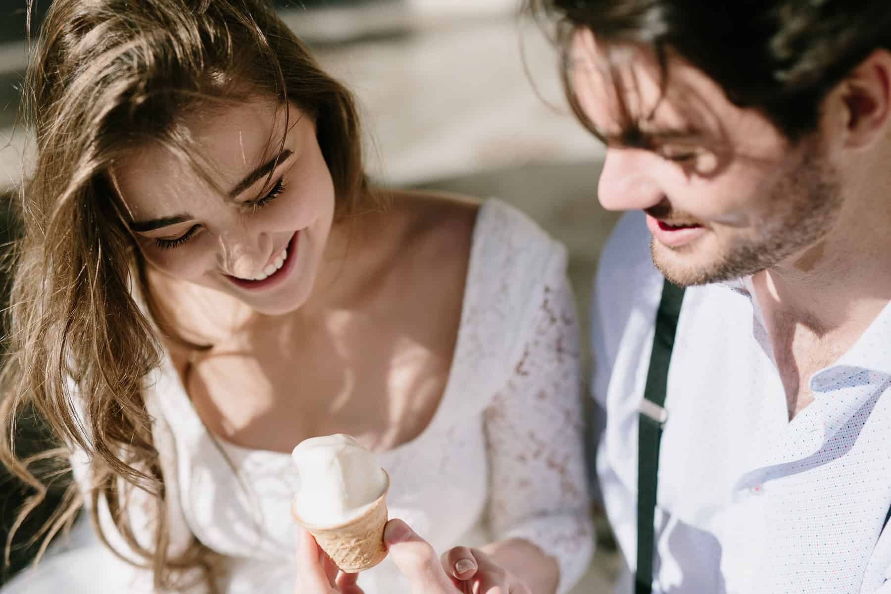 bride and groom sharing ice cream