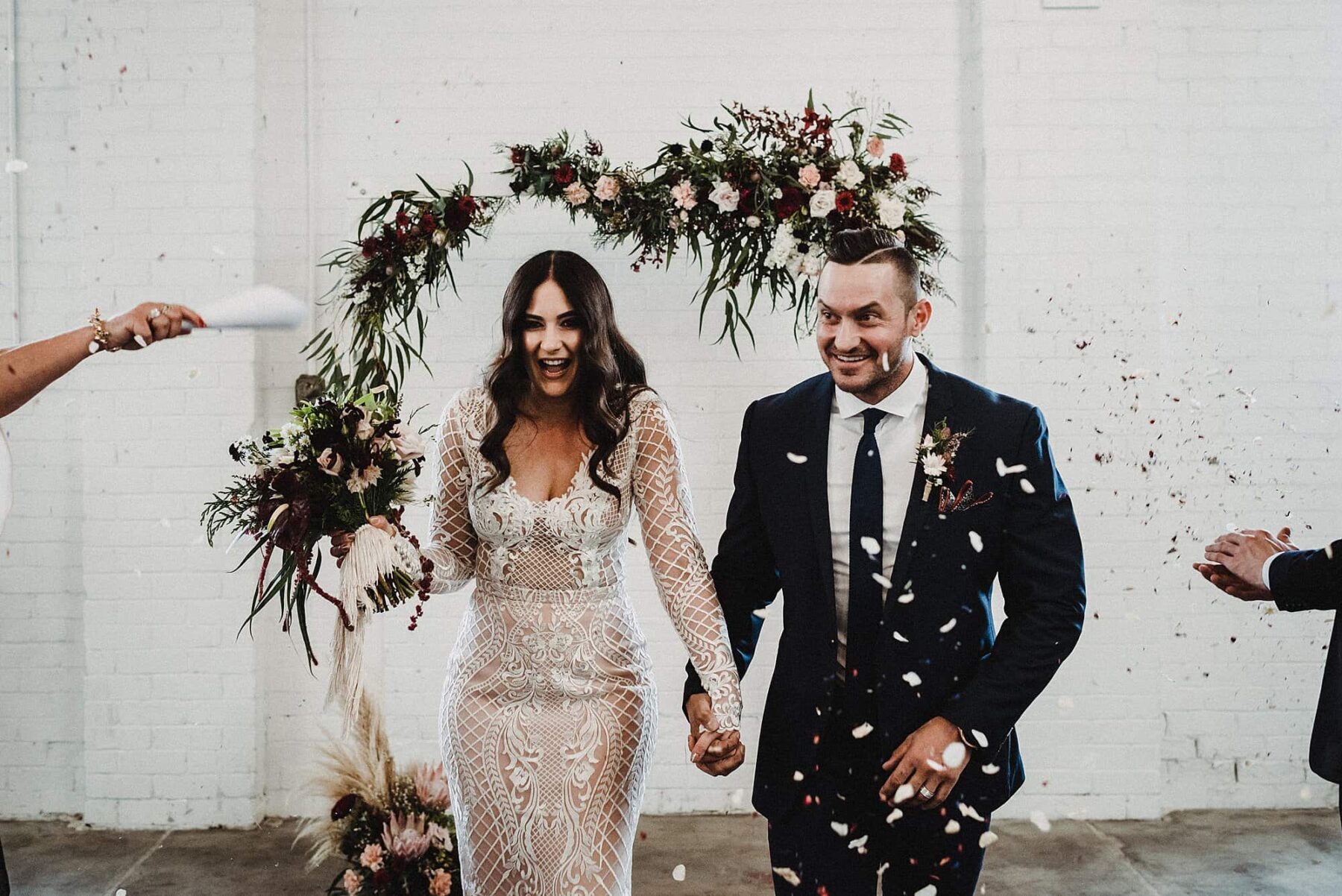 warehouse wedding with floral arch backdrop