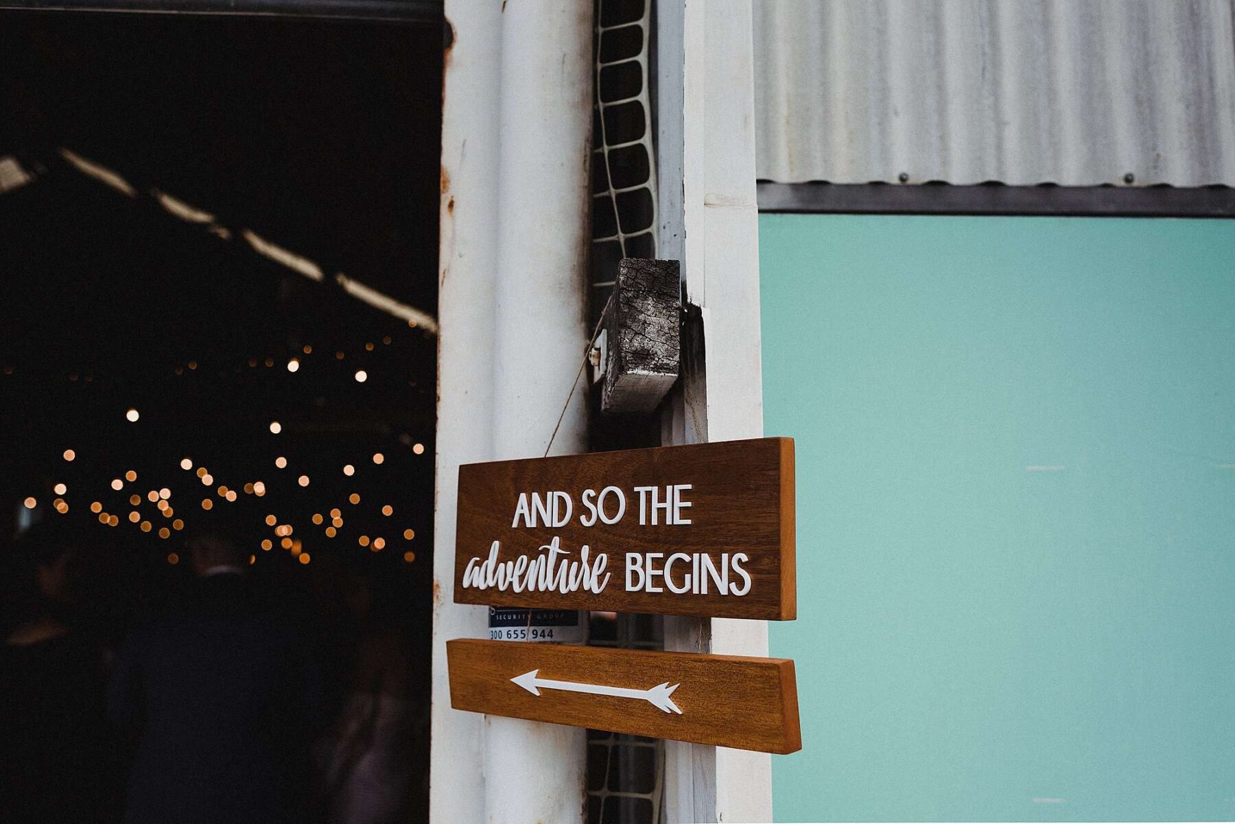 hand-lettered wooden wedding welcome sign
