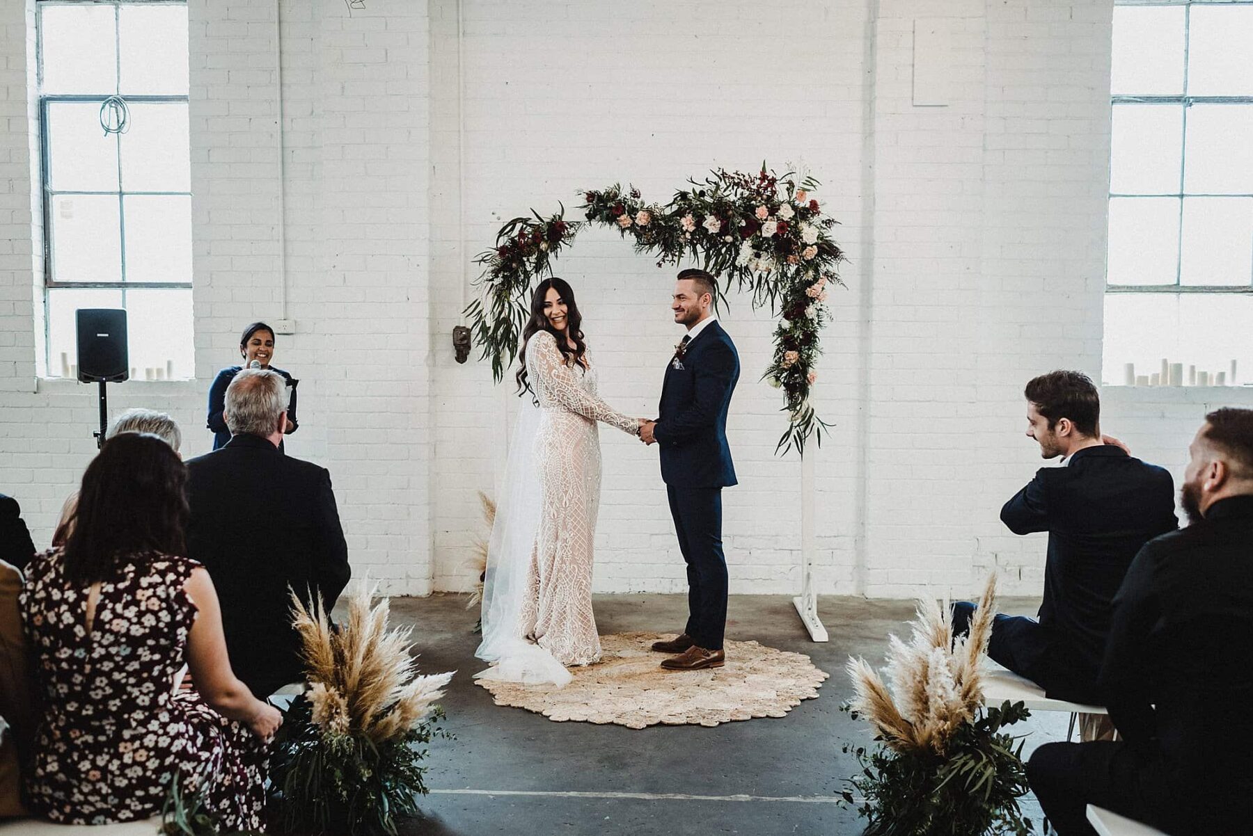 warehouse wedding with floral arch backdrop