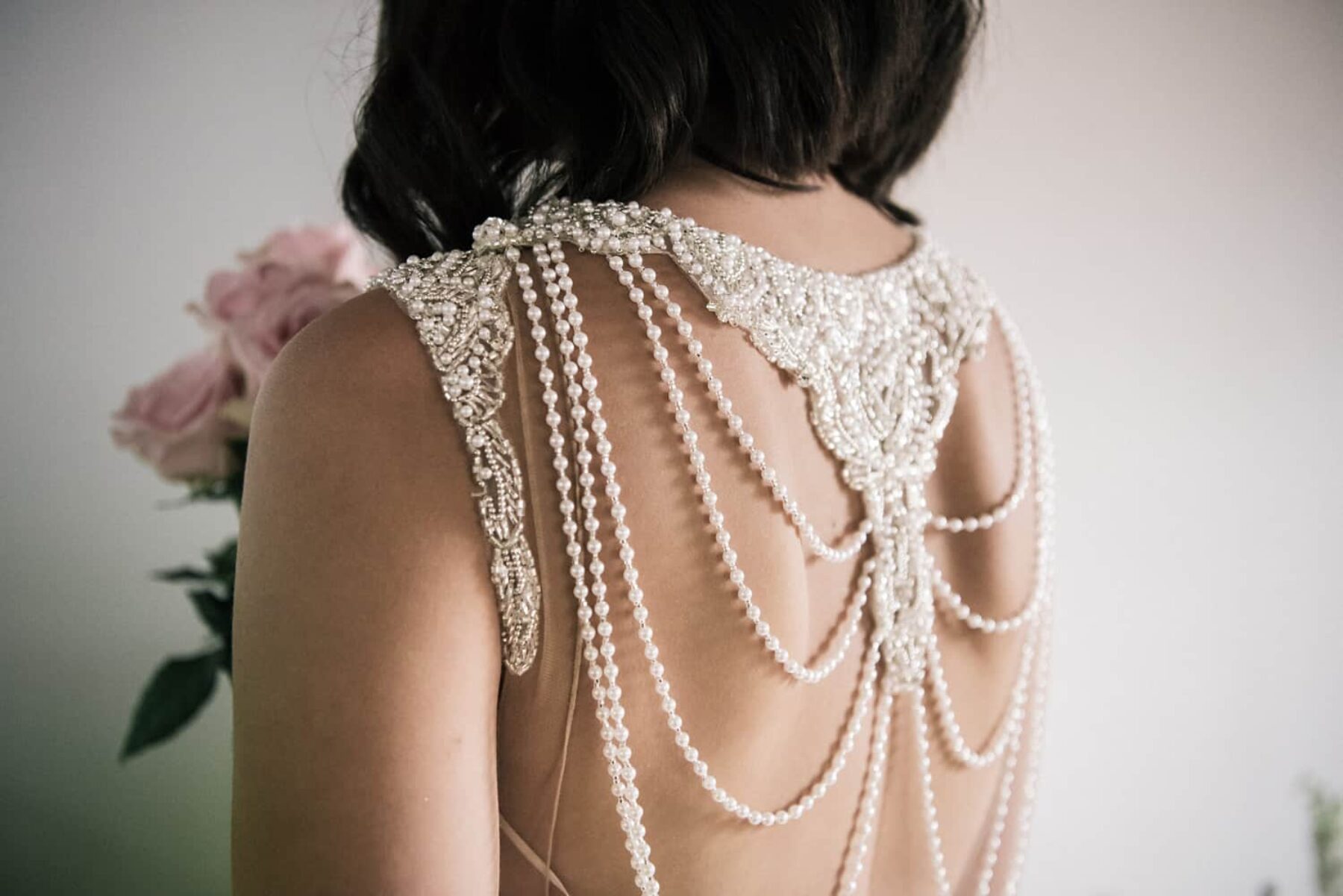 wedding dress with pearl string back detail