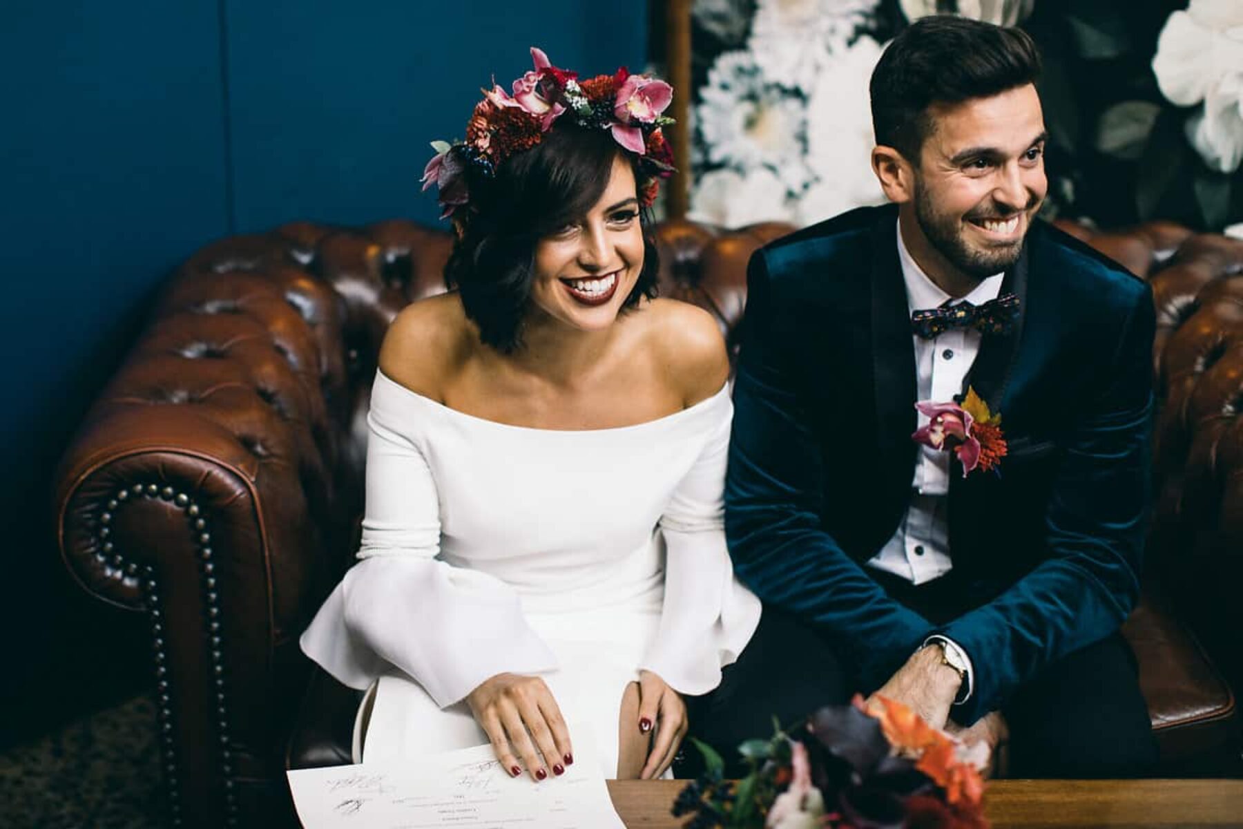modern bride in off-shoulder wedding dress and berry-toned flower crown