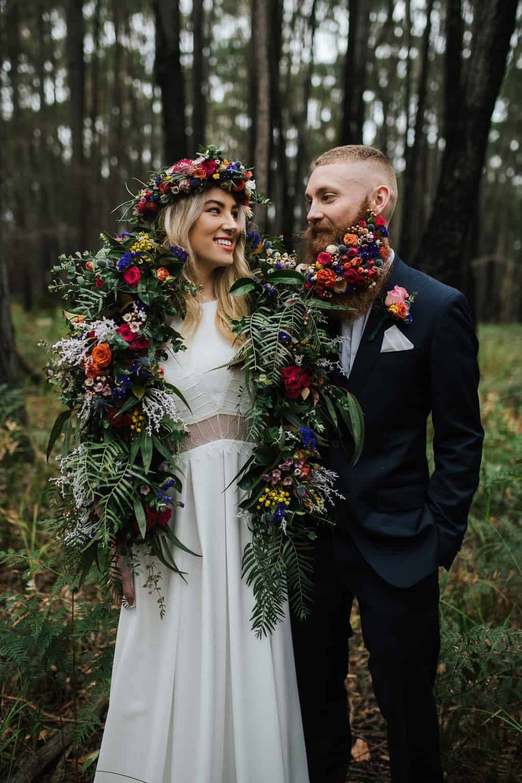 bride with flower crown and groom with floral beard