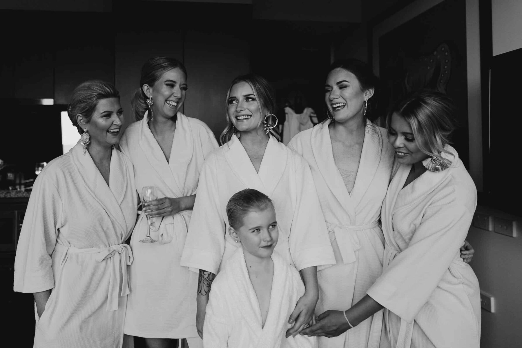 bridesmaids getting ready in white robes