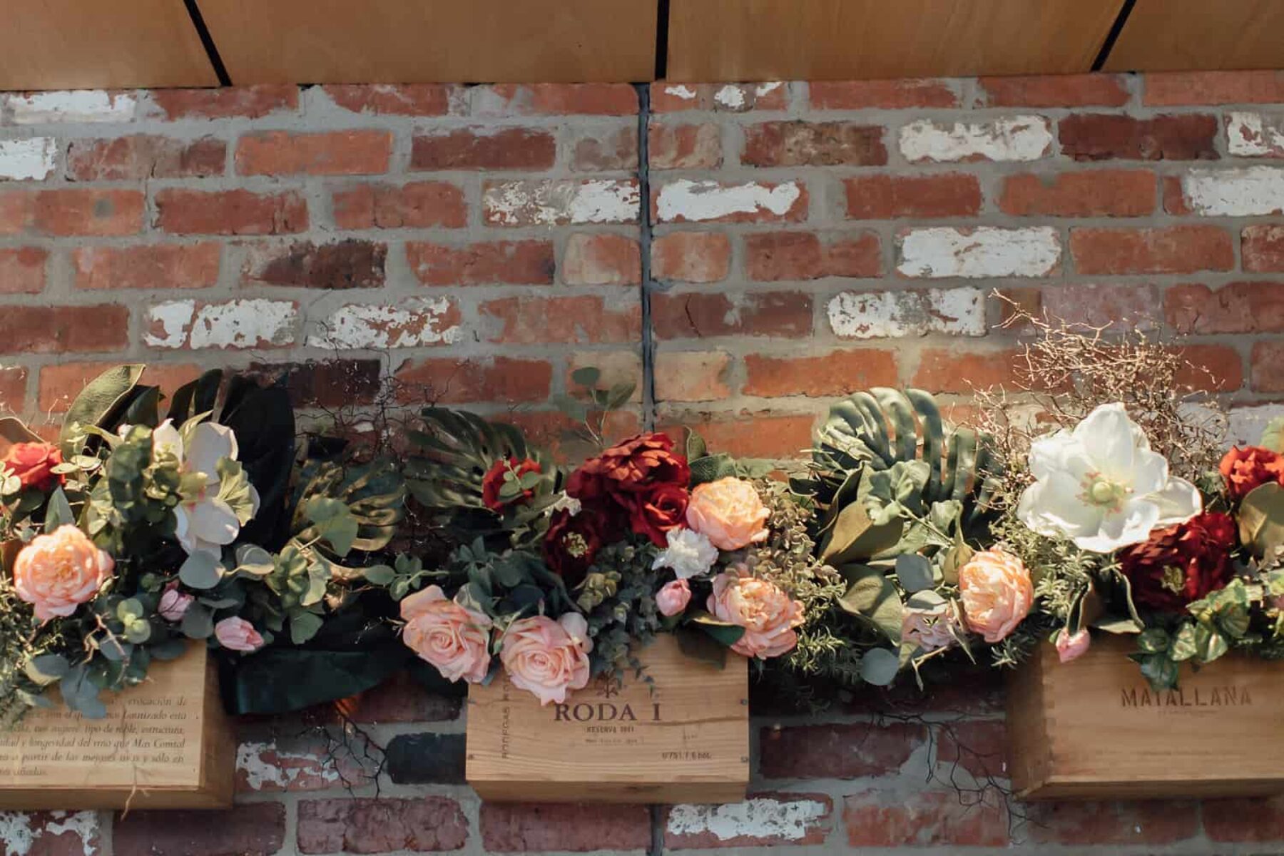 floral arch installation on exposed brick