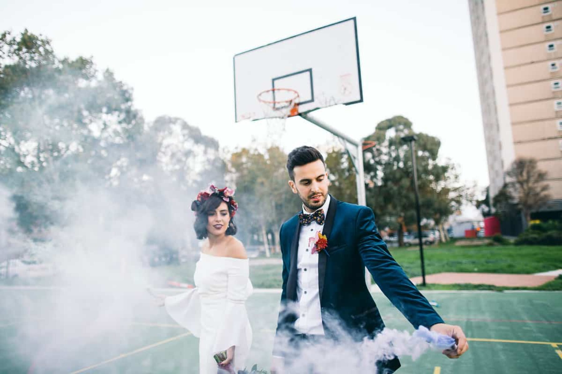 bride and groom with colour smoke bomb