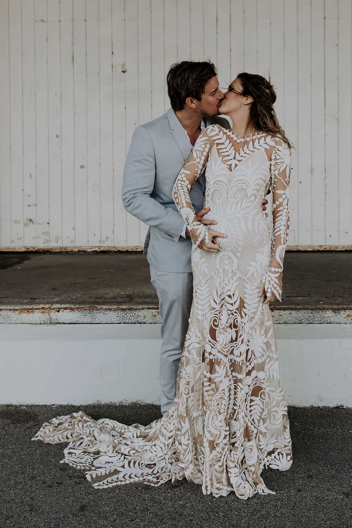 pregnant bride in long sleeve lace wedding dress