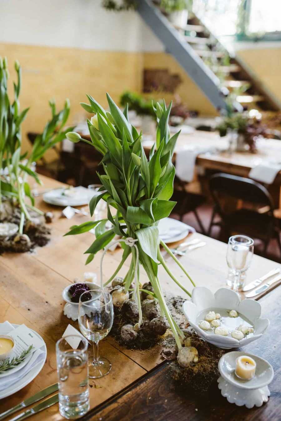 rustic long table wedding with exposed-root tulips