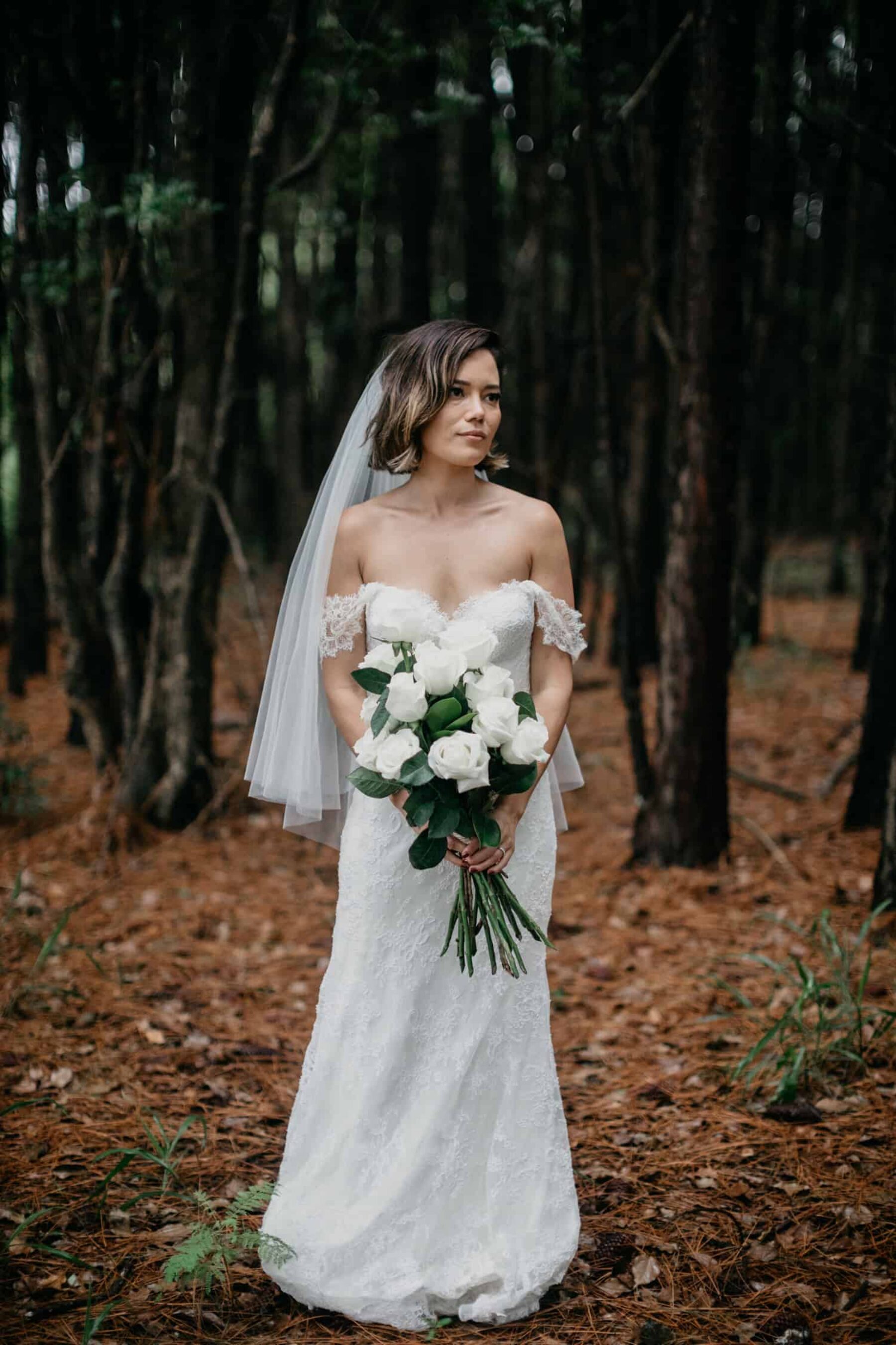 strapless wedding dress and classic white and green bouquet
