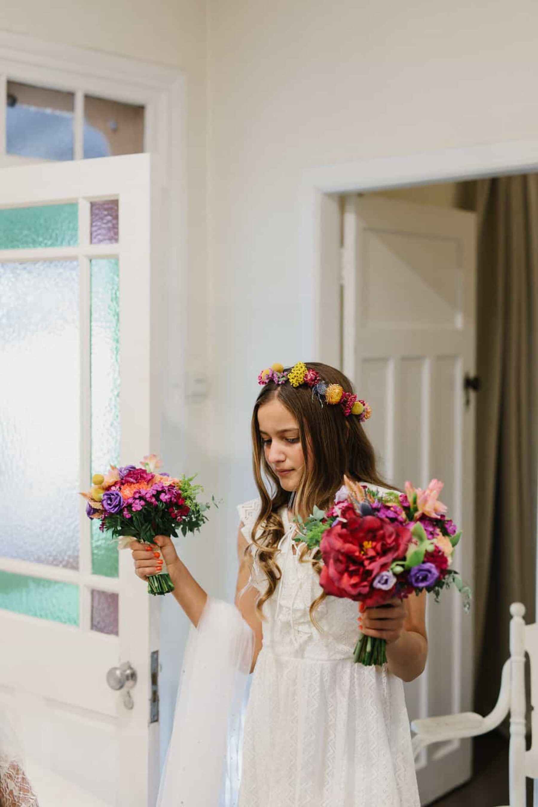 flower girl with crown and colourful bouquet