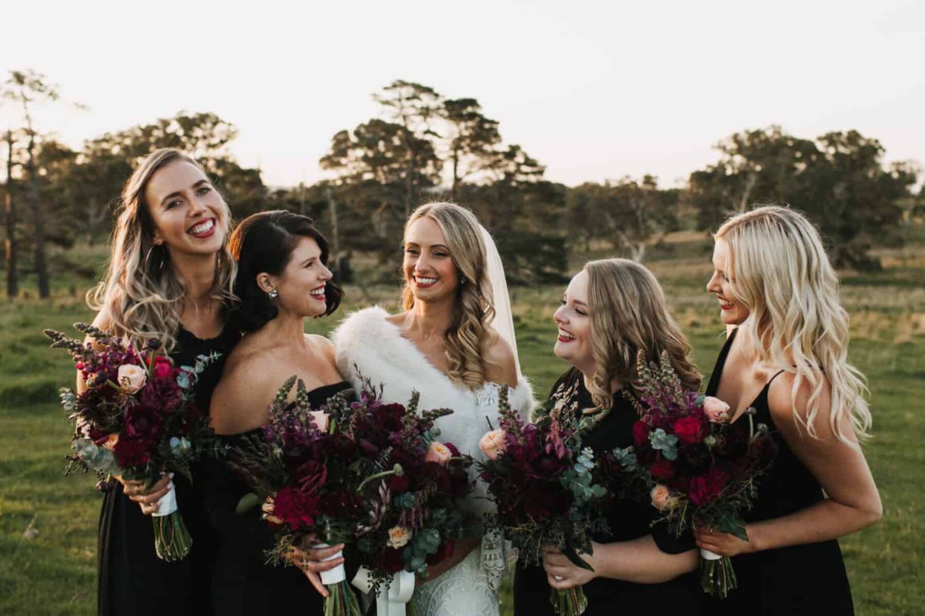 mixed black bridesmaid dresses and burgundy bouquets