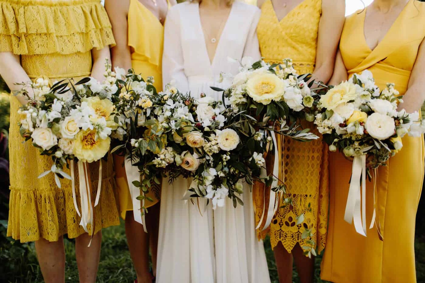 mixed yellow bridesmaid dresses and bouquets