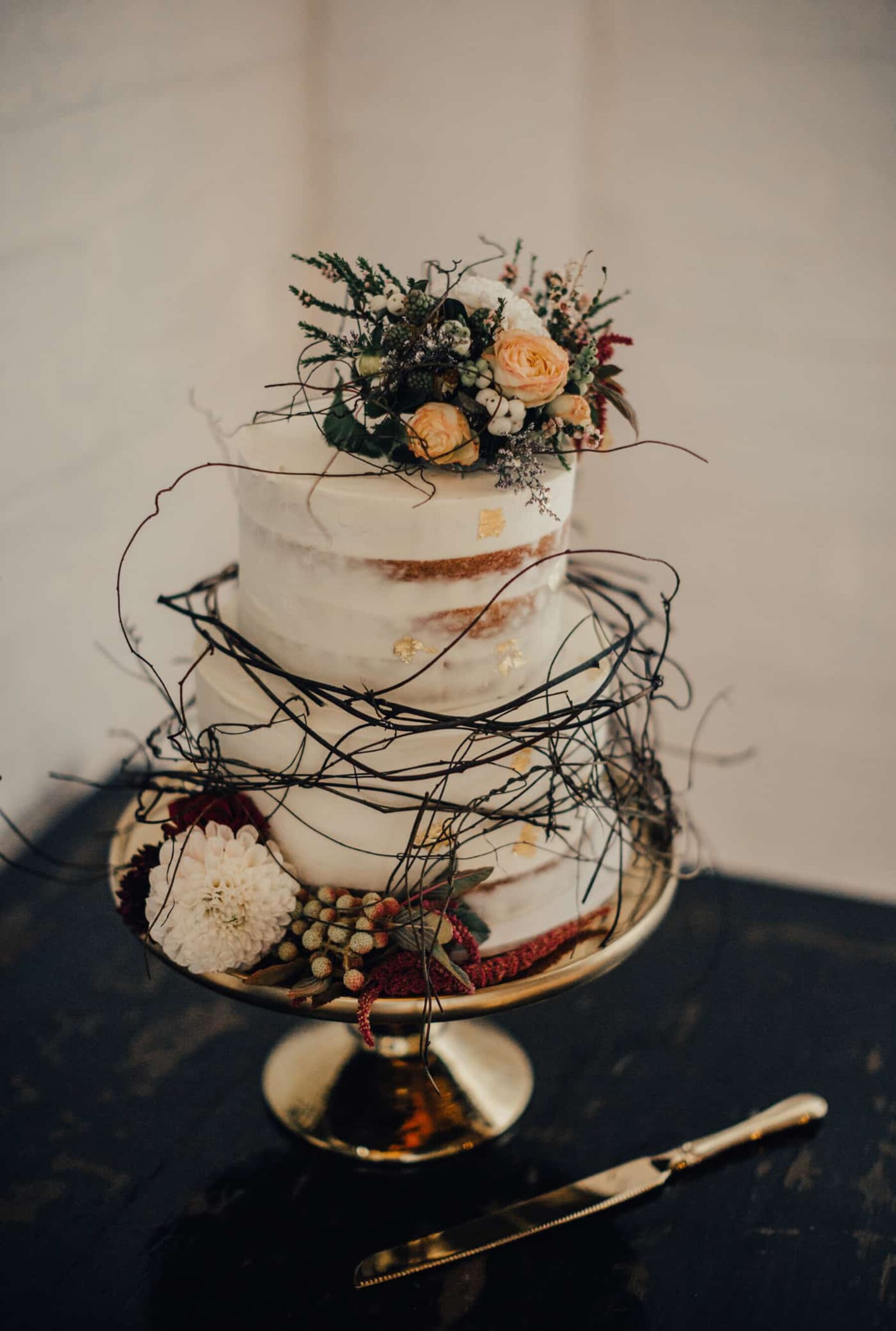 semi-naked wedding cake with fresh flowers