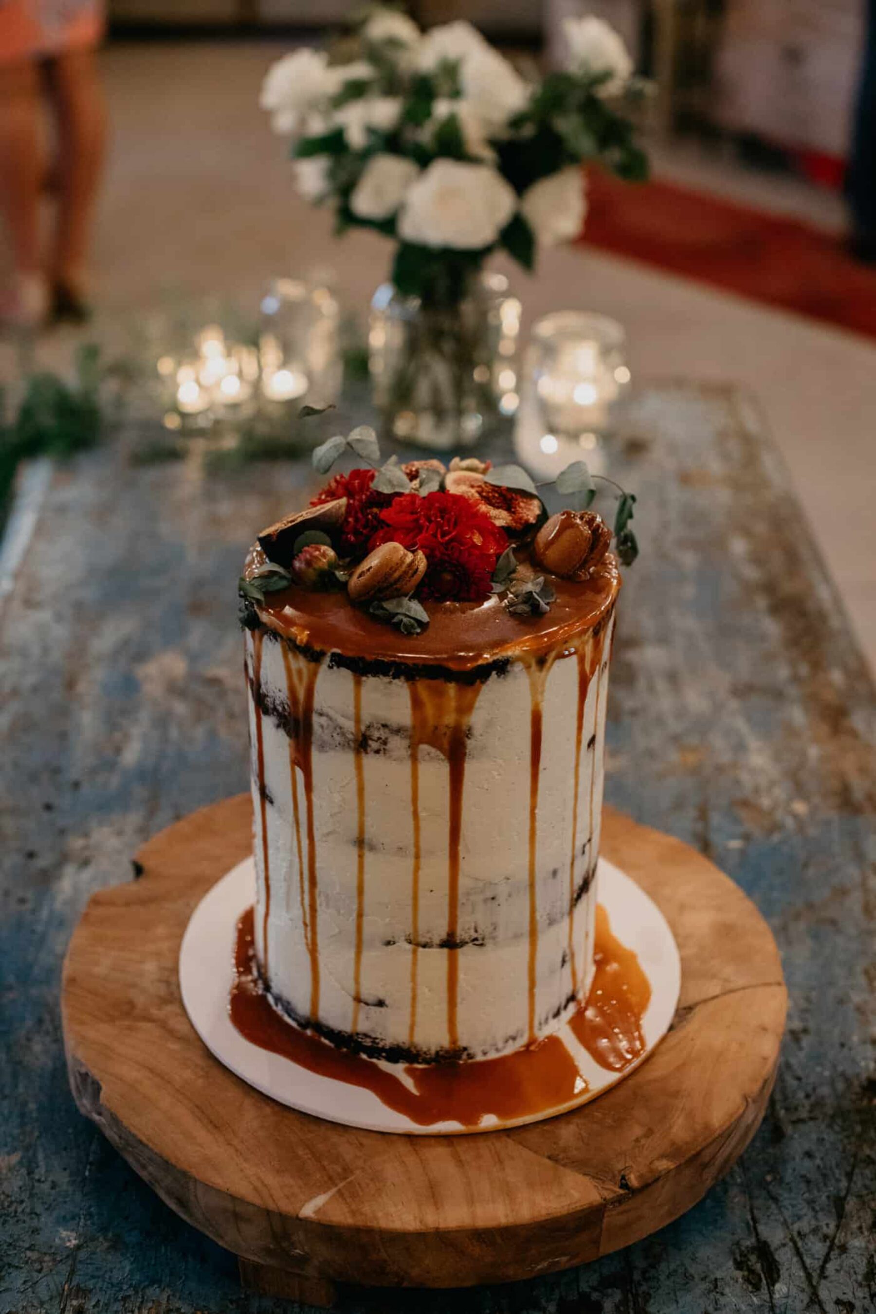 tall single tier wedding cake with caramel drip