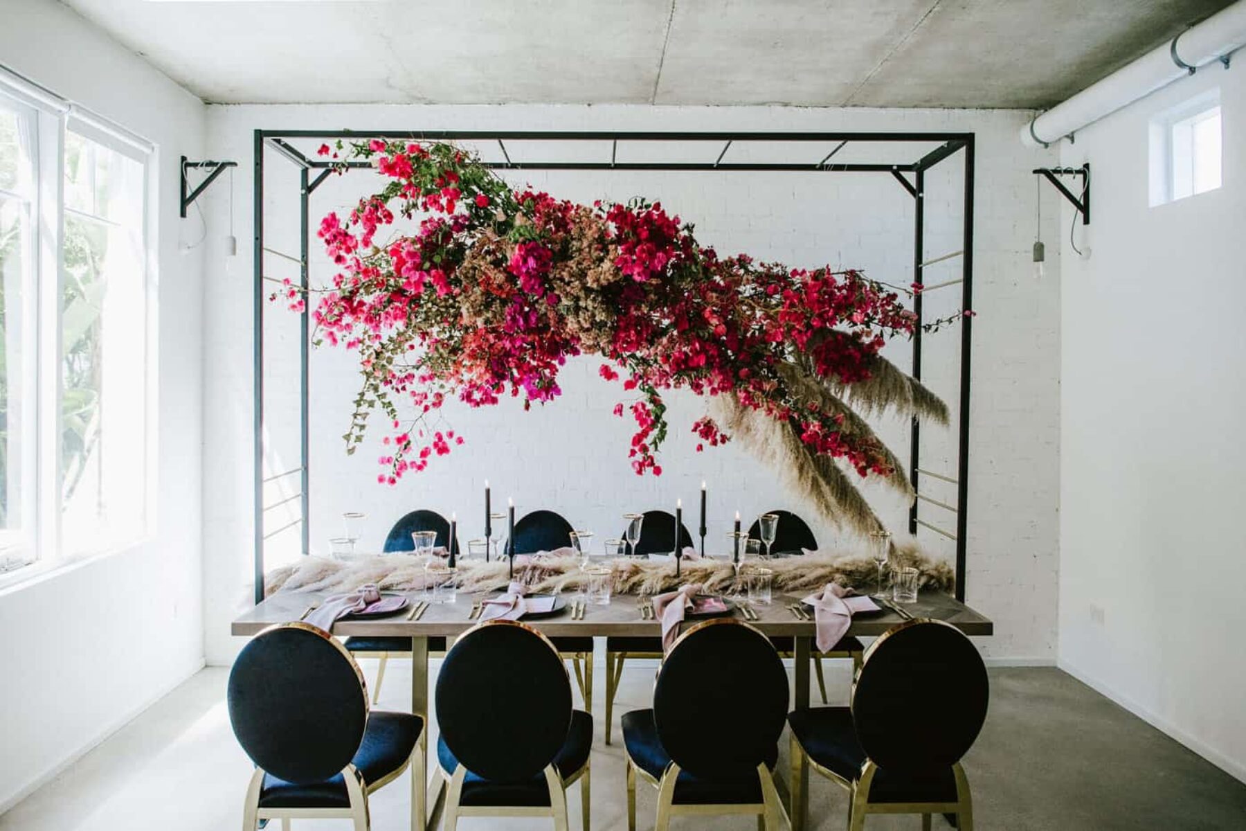 bougainvillea hanging floral installation over modern tablescape