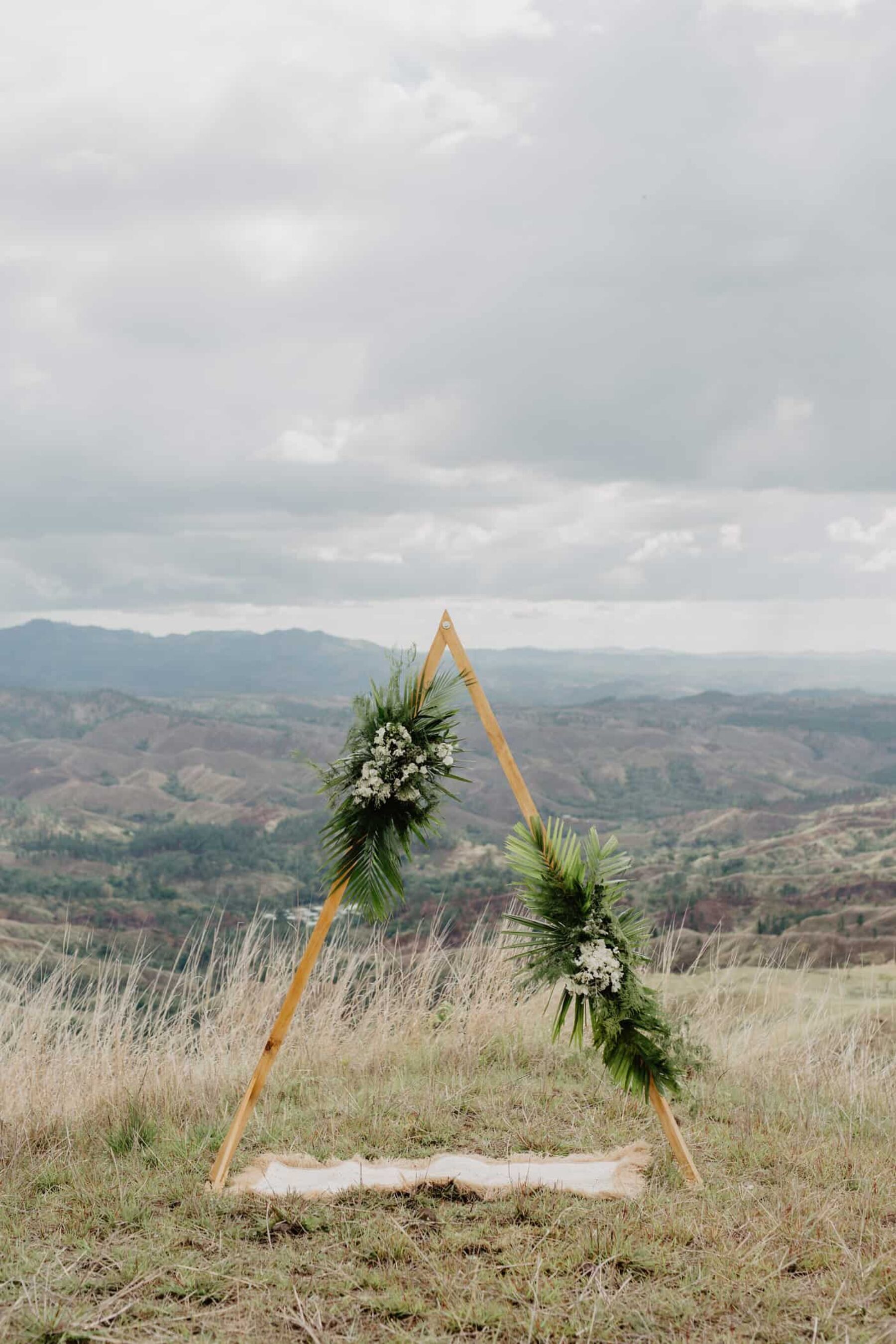 geometric triangle wedding arbour with tropical greenery