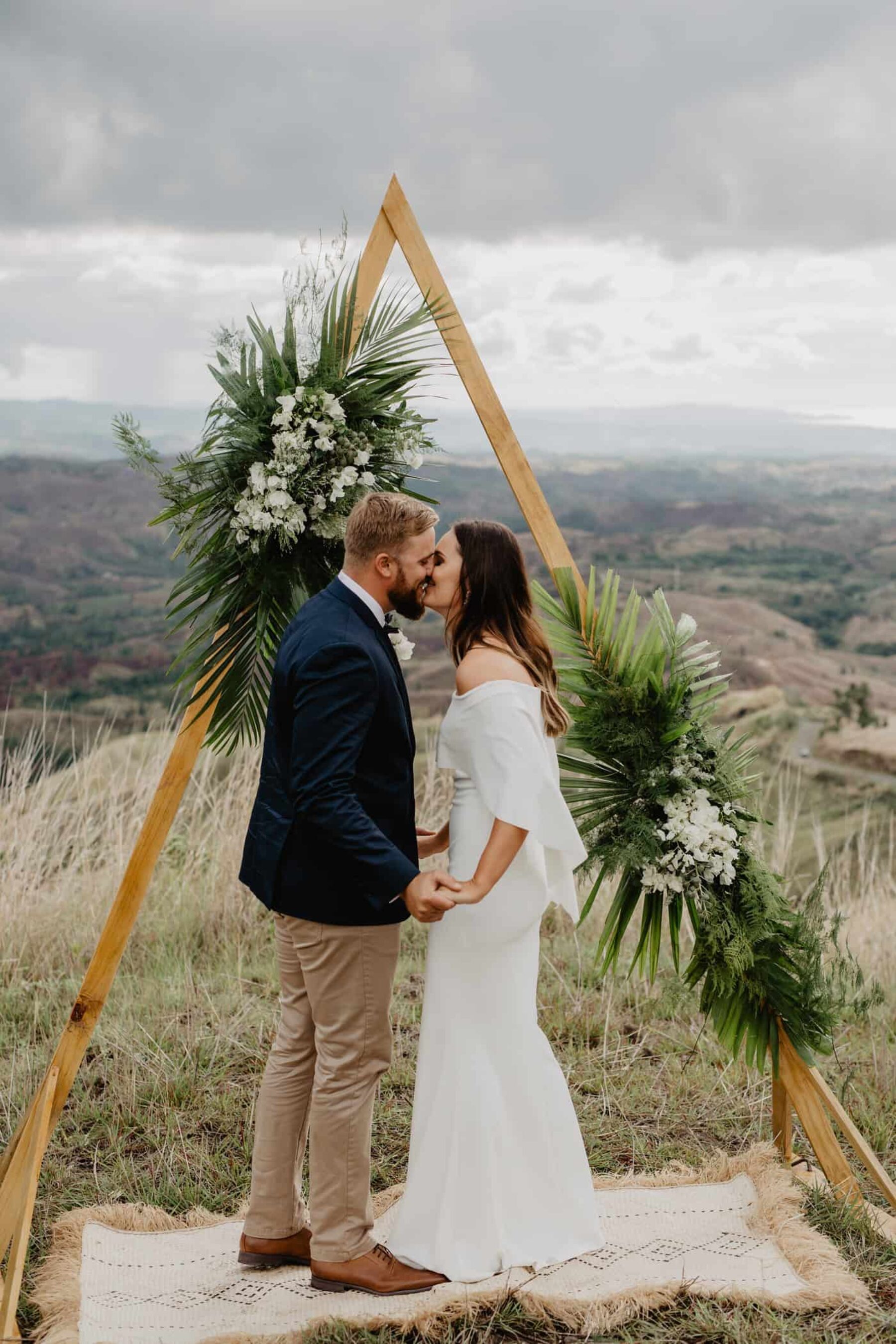 geometric triangle wedding arbour with tropical greenery
