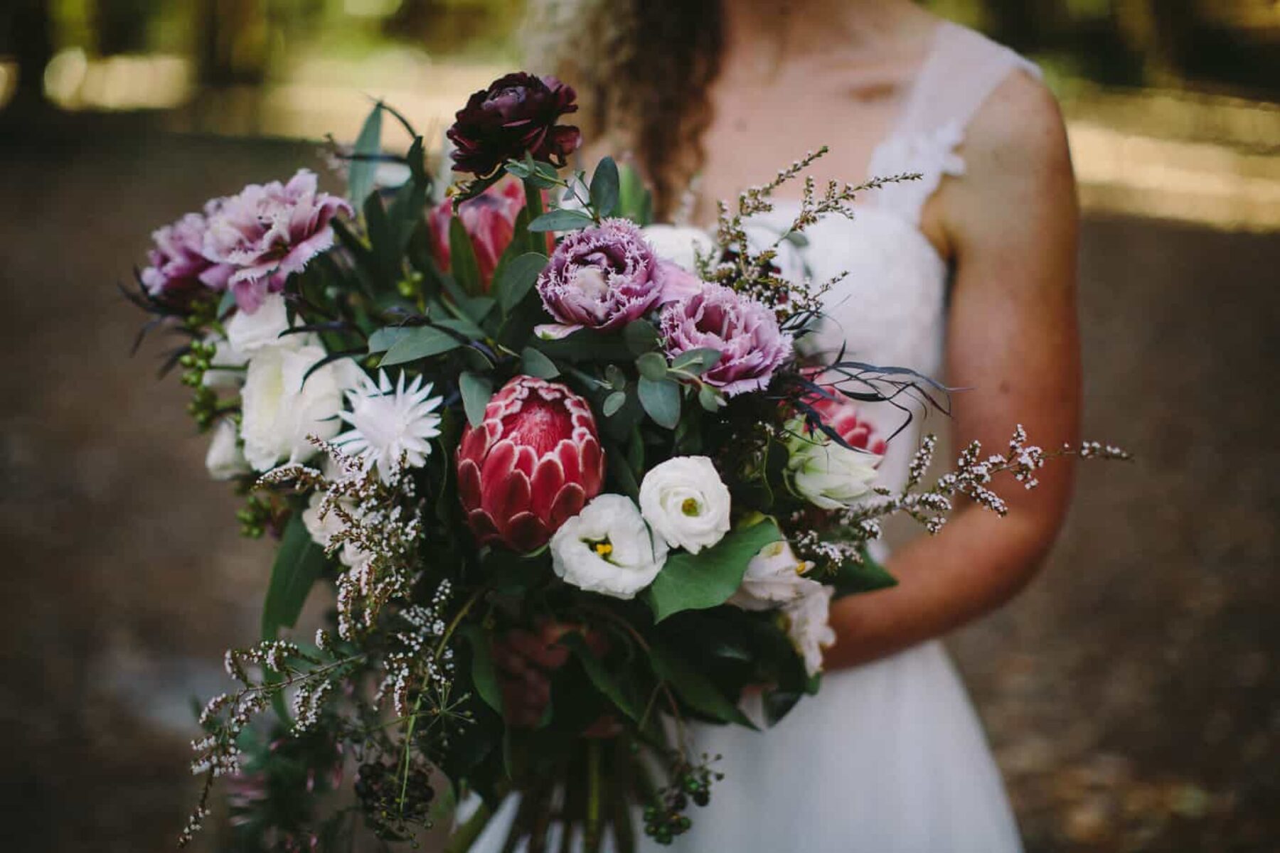 pink and purple bridal bouquet with proteas
