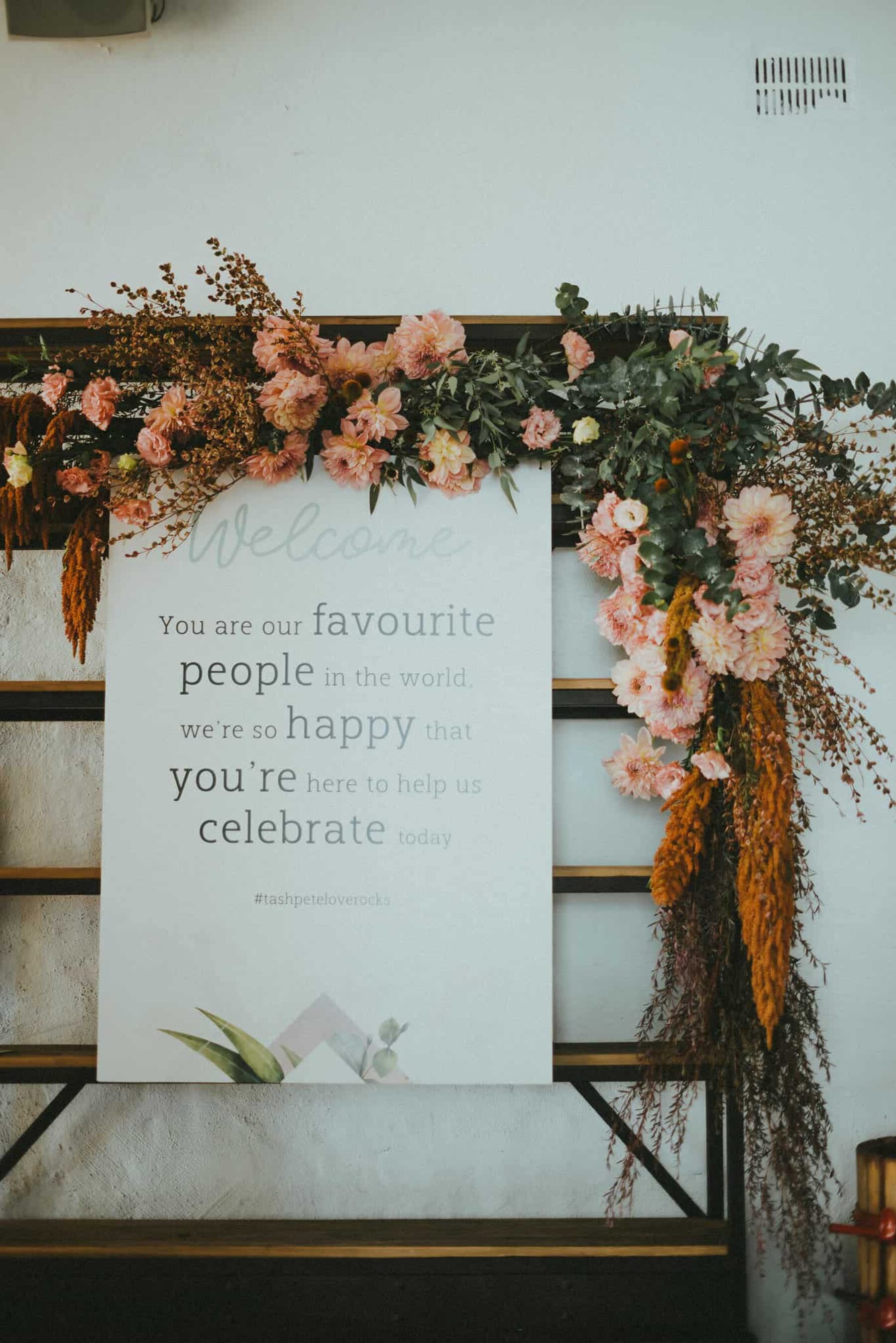 wedding welcome sign with blush dahlias
