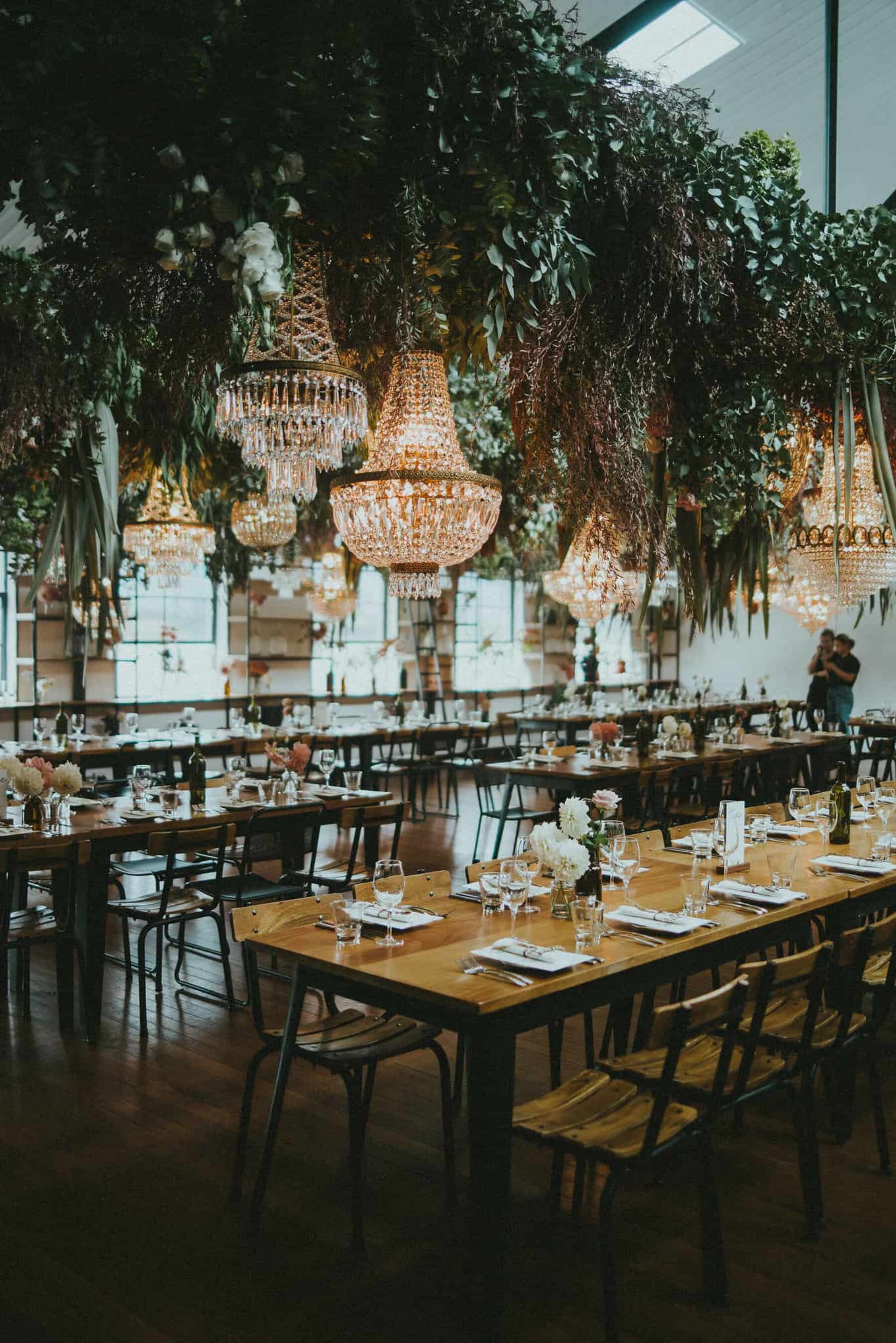 Hanging floral and foliage installations with chandeliers
