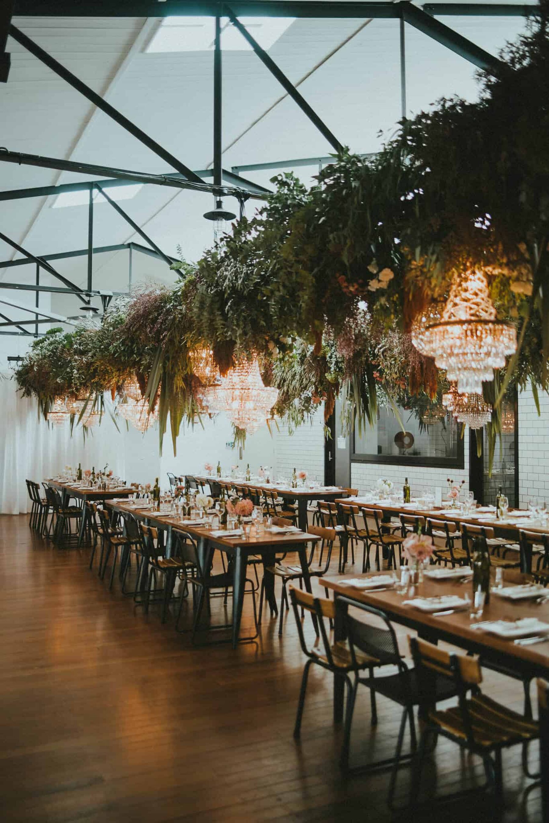 Hanging floral and foliage installations with chandeliers