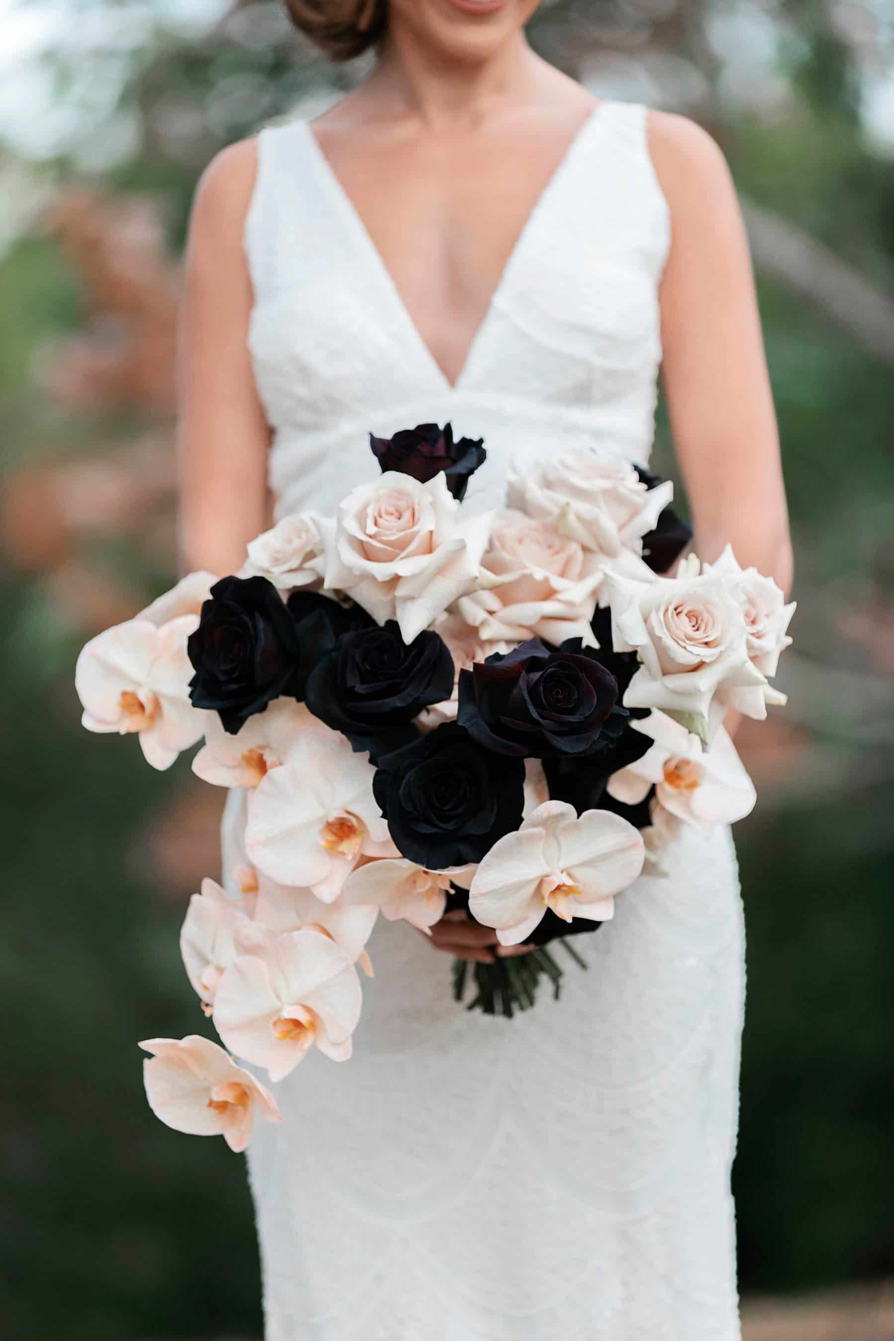 blush and bridal bouquet with orchids and black roses
