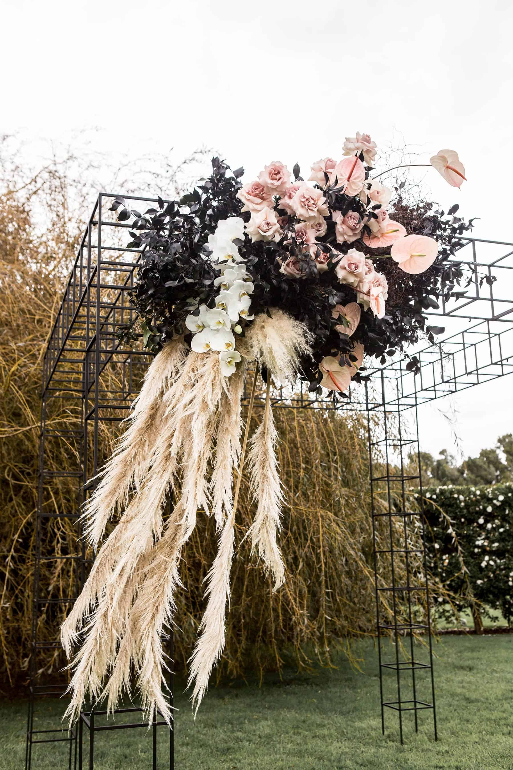 modern wire mesh wedding backdrop with blush flowers and wild grass
