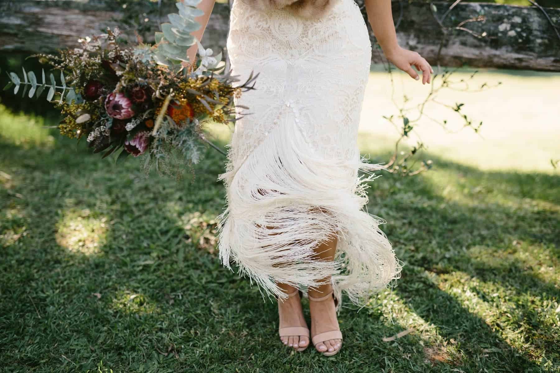 lace wedding dress with tassel hem