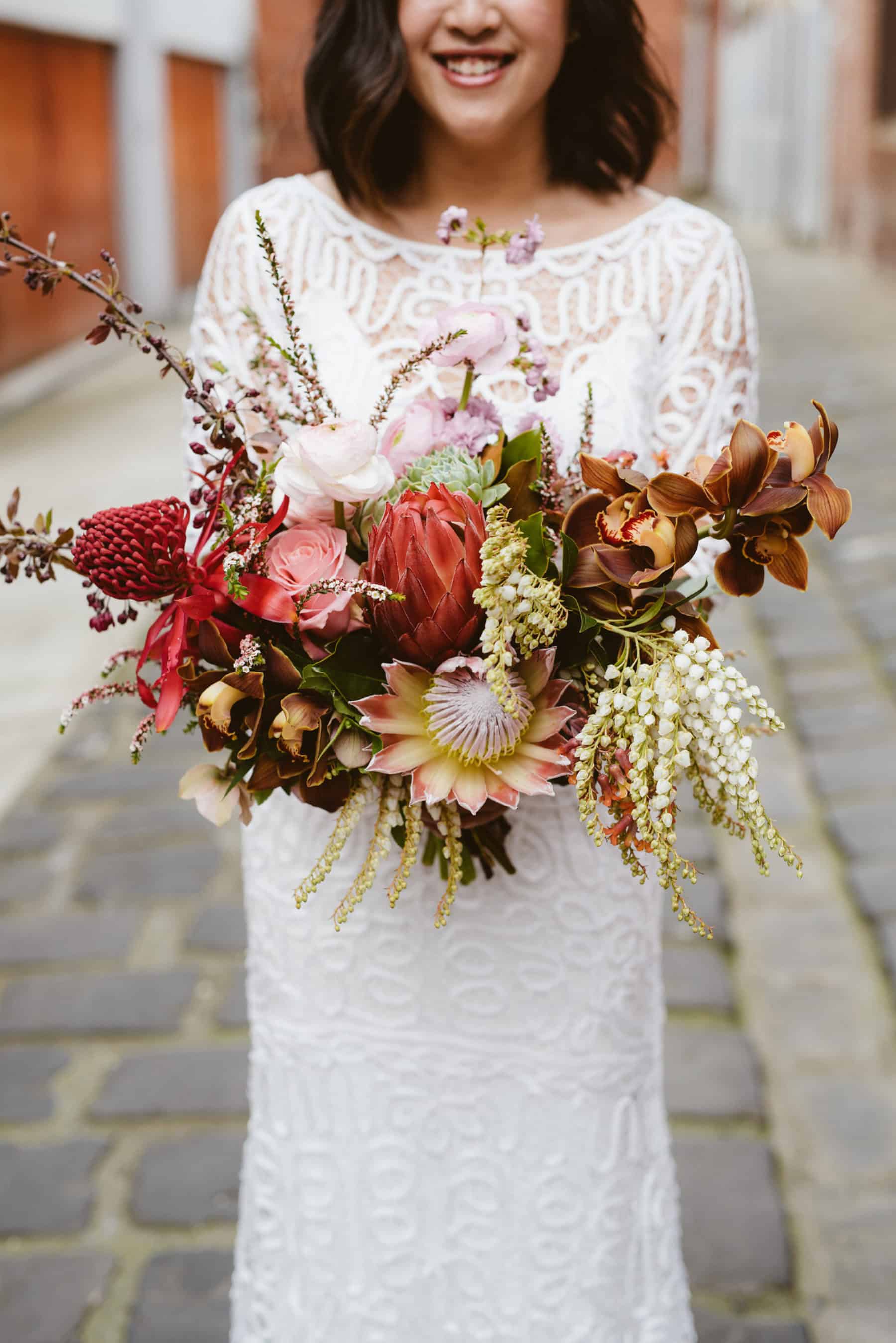 blush and dusty pink bouquet with king protea and native flowers