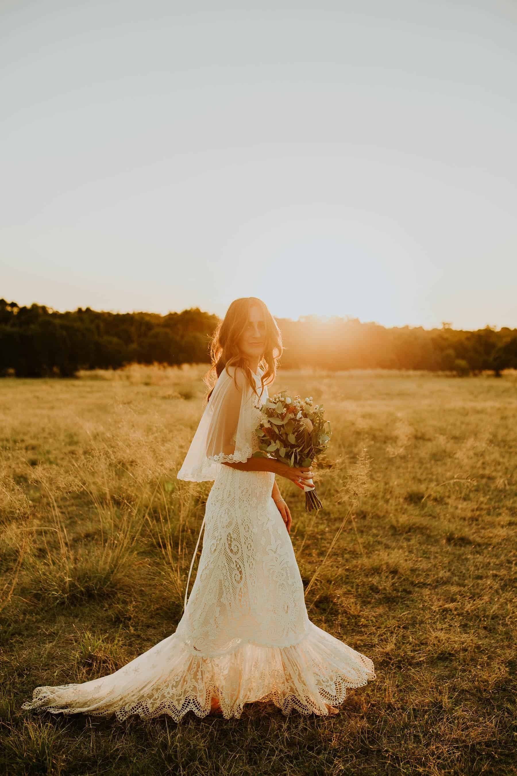 boho bride in lace wedding dress and cape by Spell Designs