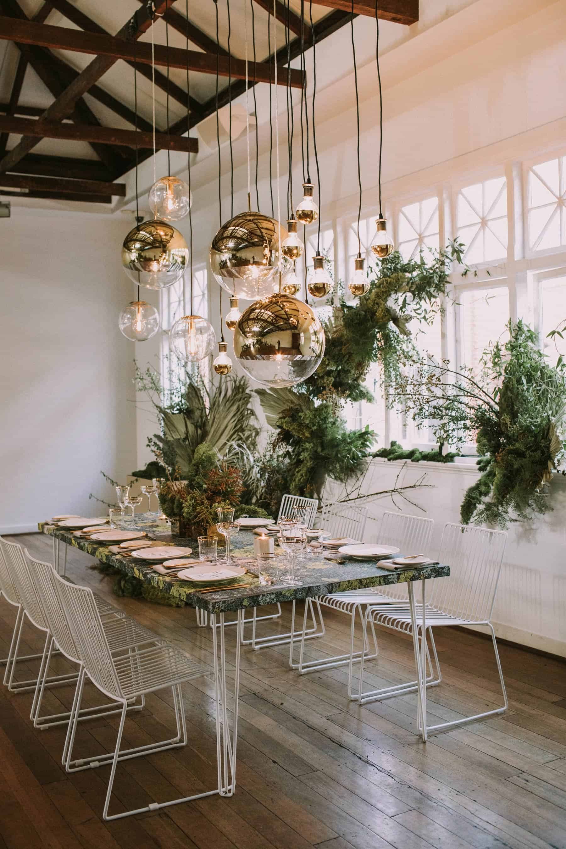 modern tablescape with gold pendant lighting