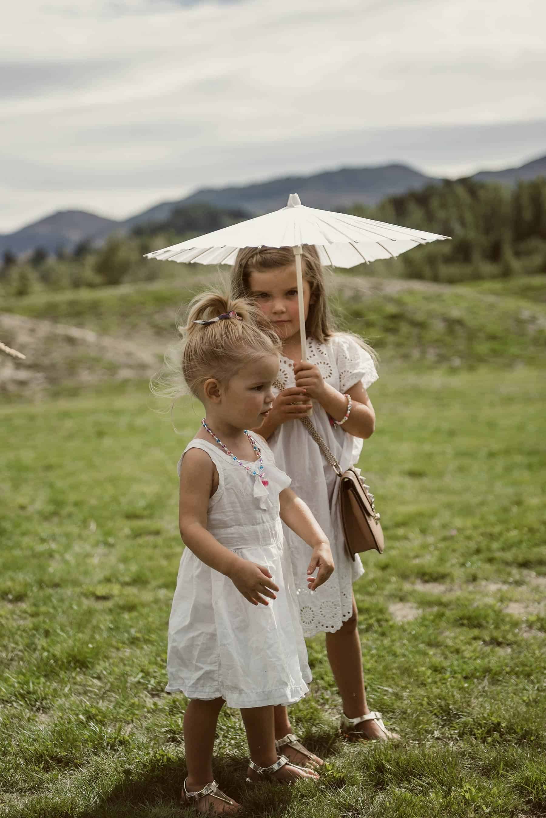 flower girls with white parasols