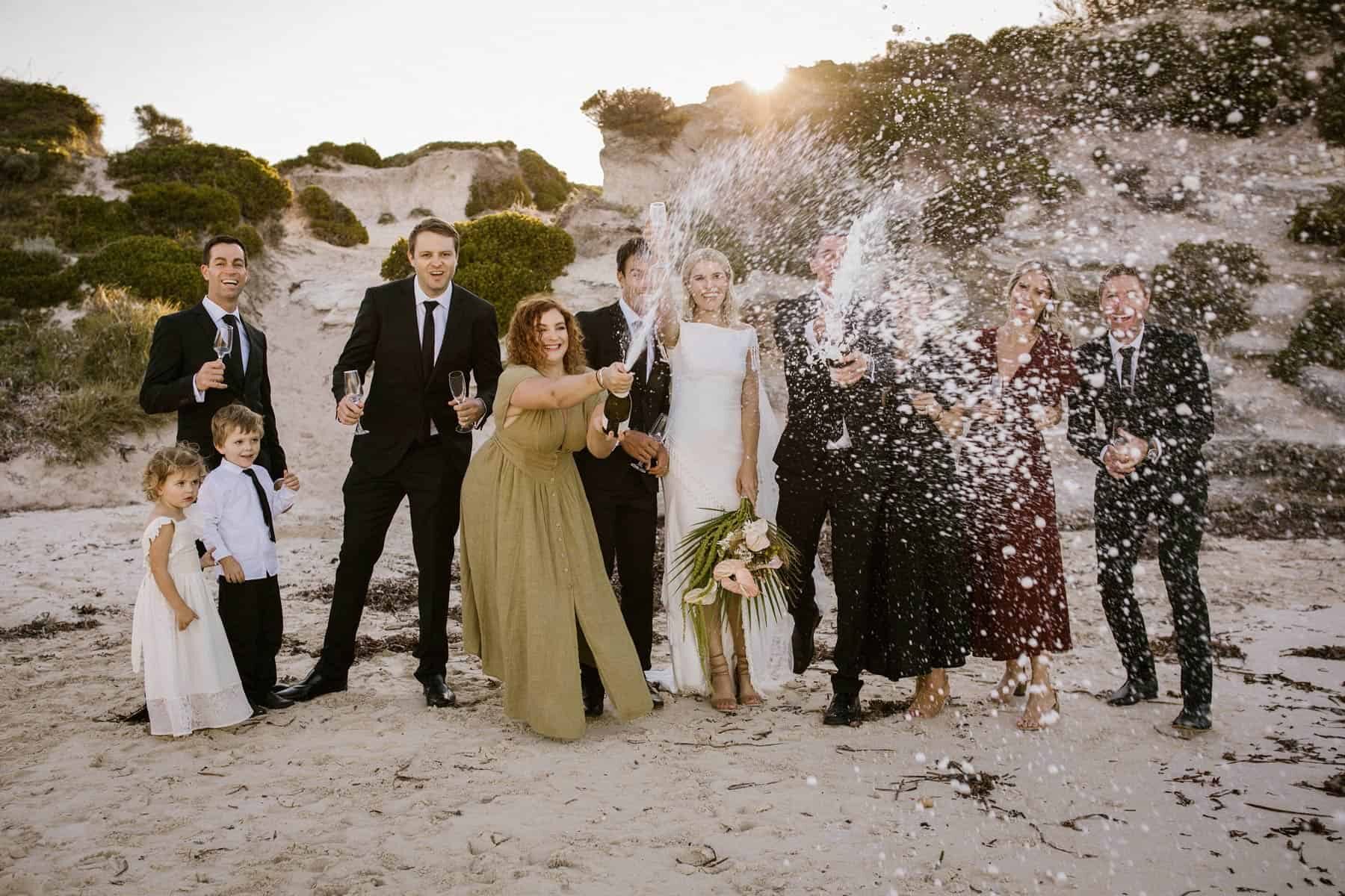 bridal party spraying champagne