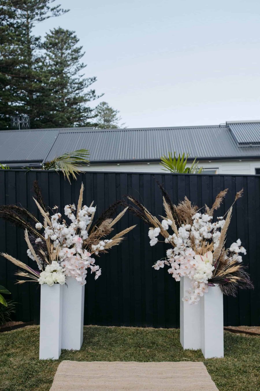 backyard wedding with modern floral backrop
