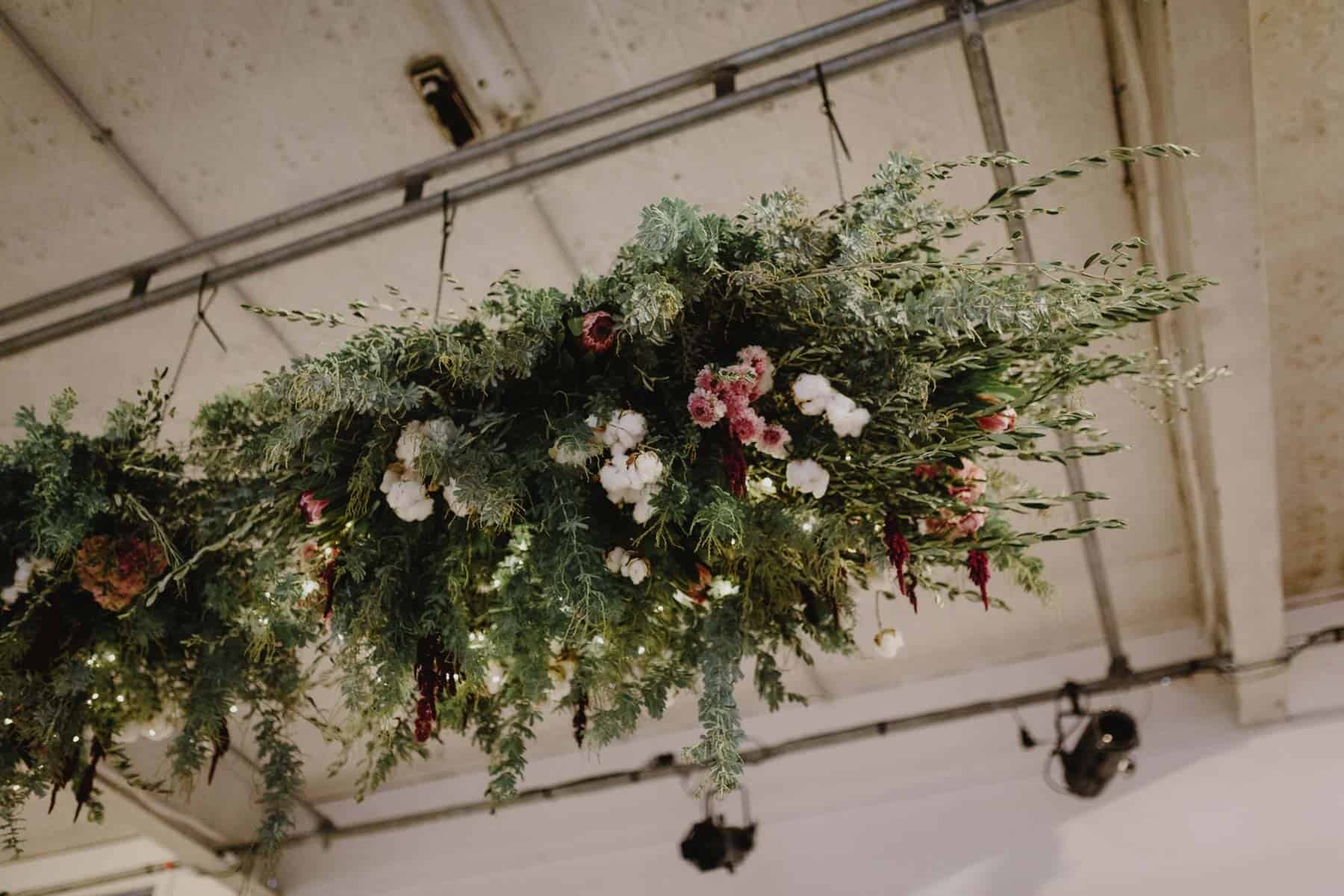 hanging floral and foliage installaton with cotton and amaranth