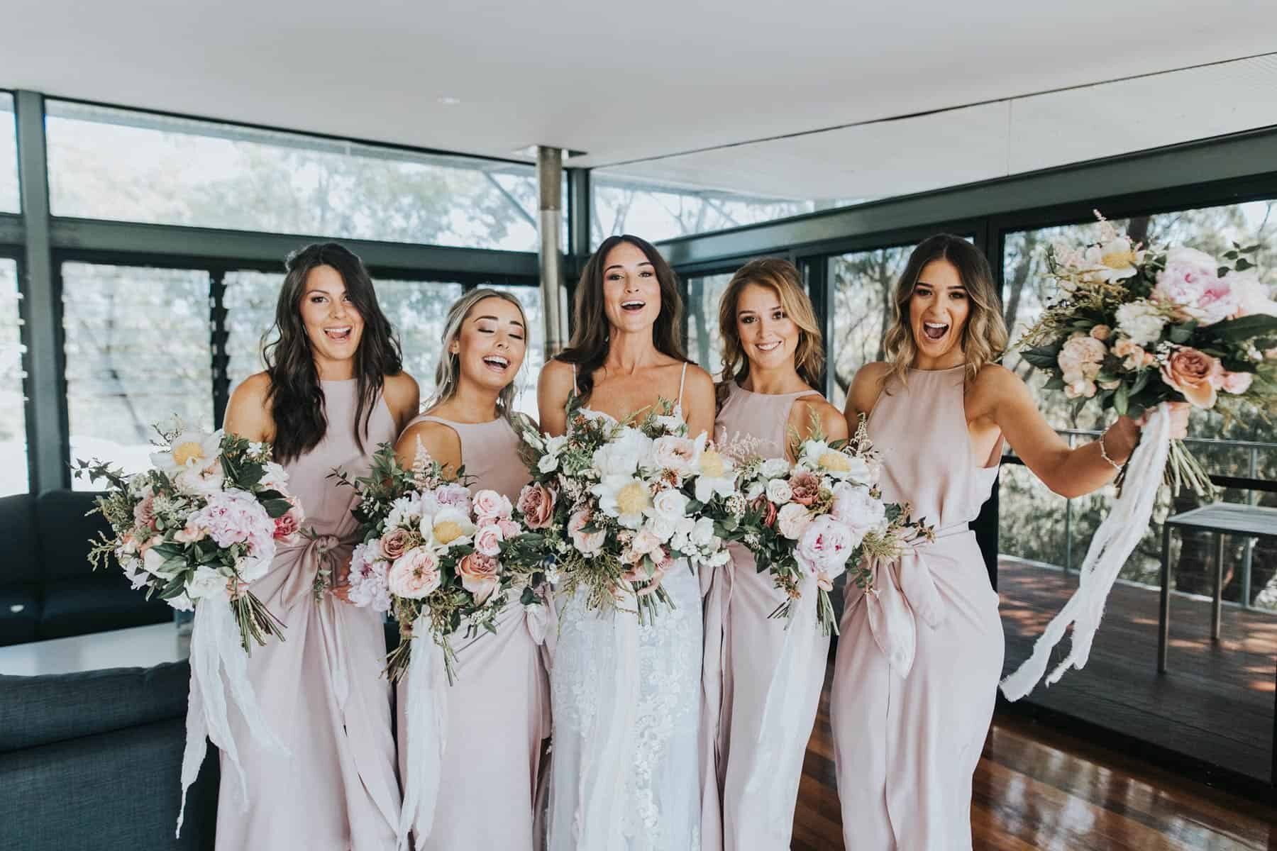 modern blush bridesmaid dresses and wild bouquets