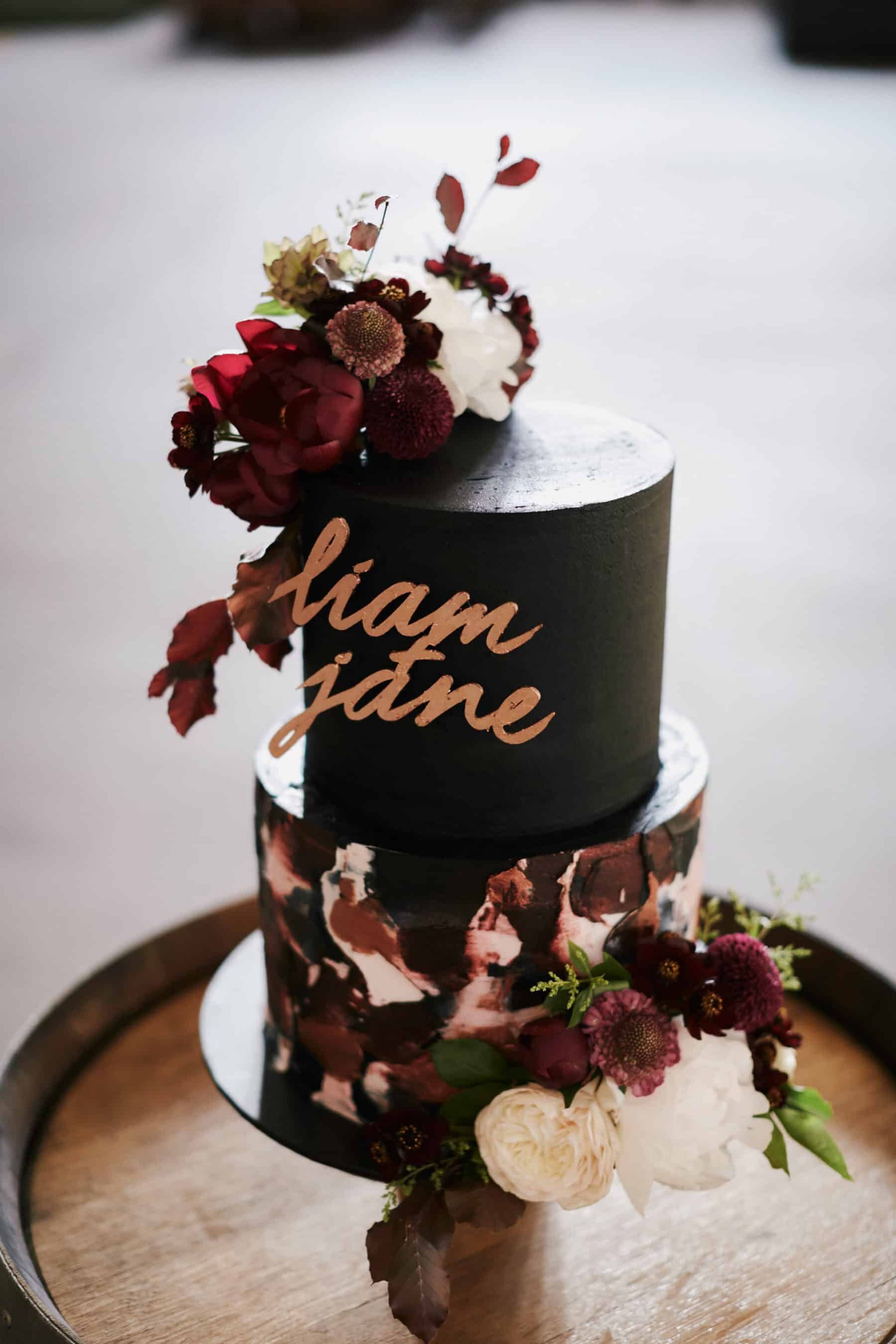 black wedding cake with laser cut topper